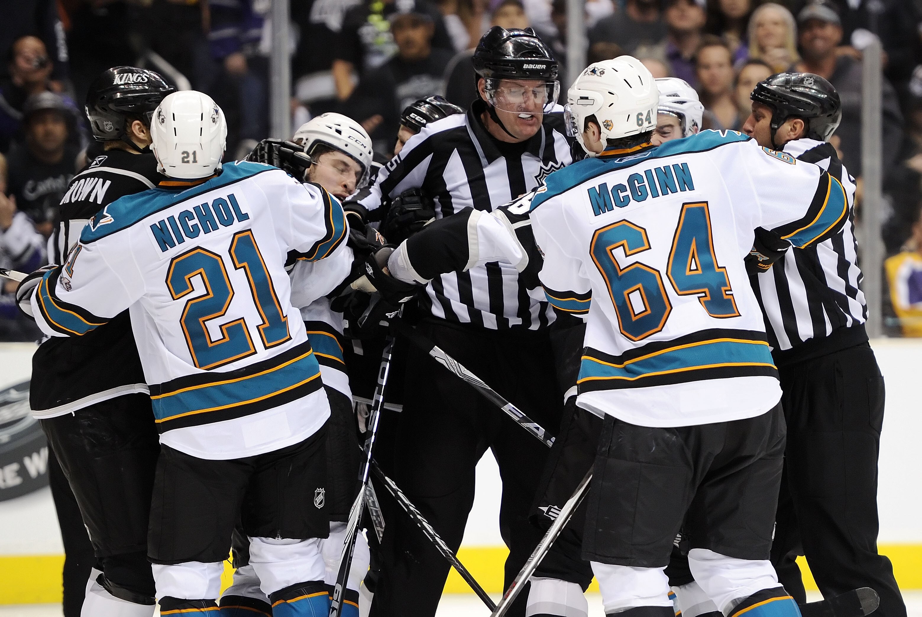 LOS ANGELES, CA - APRIL 25:  The referees break up a scuffle between the San Jose Sharks and the Los Angeles Kings in game six of the Western Conference Quarterfinals during the 2011 NHL Stanley Cup Playoffs at Staples Center on April 25, 2011 in Los Ange