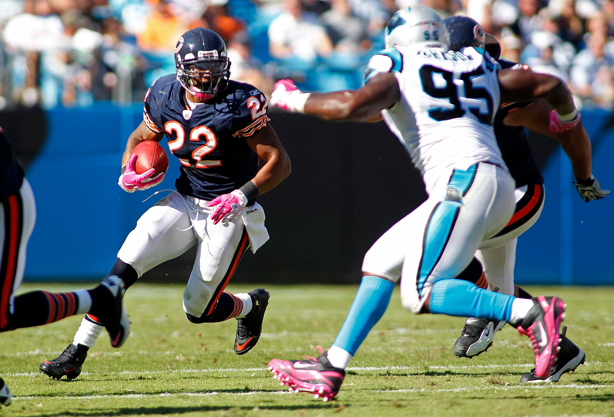 CHARLOTTE, NC - OCTOBER 10: Running back Matt Forte #22 of the Chicago Bears runs with the ball as defensive end Charles Johnson #95 of the Carolina Panthers defends at Bank of America Stadium on October 10, 2010 in Charlotte, North Carolina. (Photo by Ge