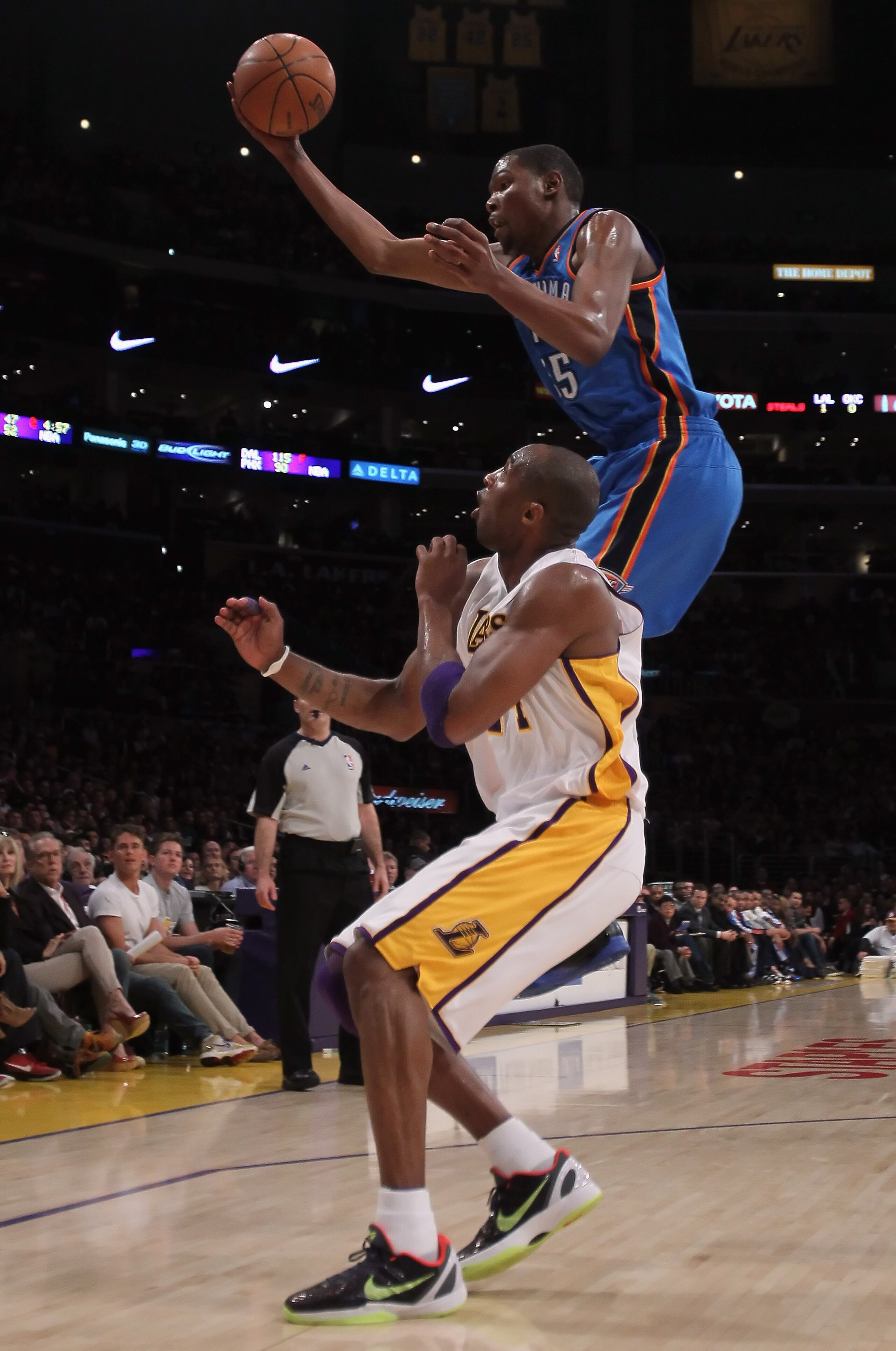 LOS ANGELES, CA - APRIL 10:  Kevin Durant #35 of the Oklahoma City Thunder rebounds a ball over Kobe Bryant #24 of the Los Angeles Lakers in the first half at Staples Center on April 10, 2011 in Los Angeles, California. The Thunder defeated the Lakers 120