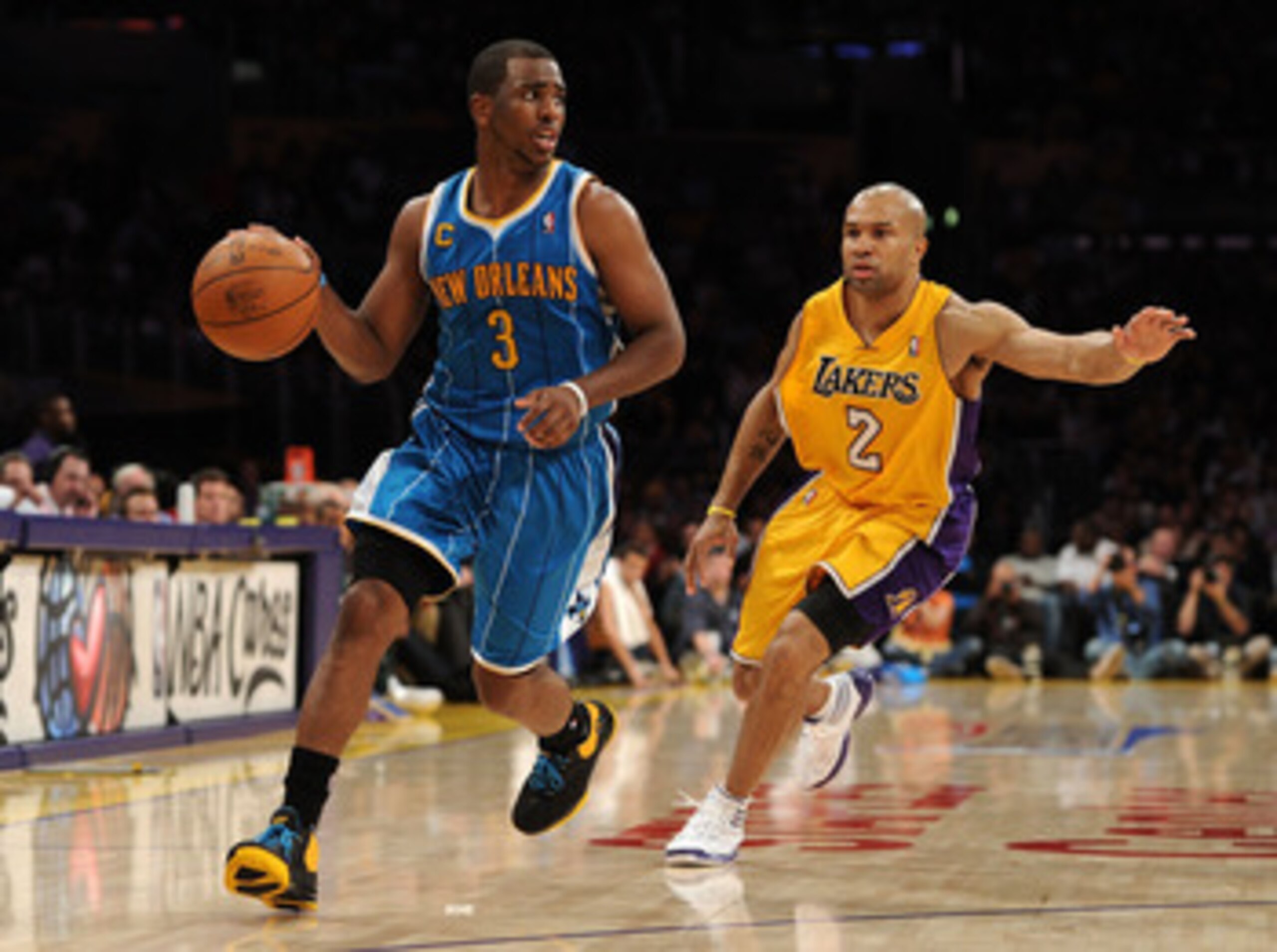 LOS ANGELES, CA - APRIL 20:  Chris Paul #3 of the New Orleans Hornets drives on Derek Fisher #2 of the Los Angeles Lakers in Game Two of the Western Conference Quarterfinals in the 2011 NBA Playoffs on April 20, 2011 at Staples Center in Los Angeles, Cali