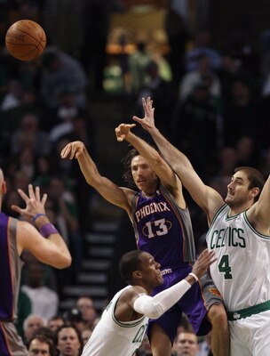BOSTON, MA - MARCH 02:  Steve Nash #13 of the Phoenix Suns passes the ball as Nenad Krstic #4 of the Boston Celtics and Rajon Rondo defend on March 2, 2011 at the TD Garden in Boston, Massachusetts.  NOTE TO USER: User expressly acknowledges and agrees th