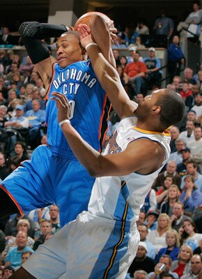 DENVER, CO - APRIL 23:  Russell Westbrook #0 of the Oklahoma City Thunder is fouled by Arron Afflalo #6 of the Denver Nuggets in Game Three of the Western Conference Quarterfinals in the 2011 NBA Playoffs at Pepsi Center on April 23, 2011 in Denver, Color