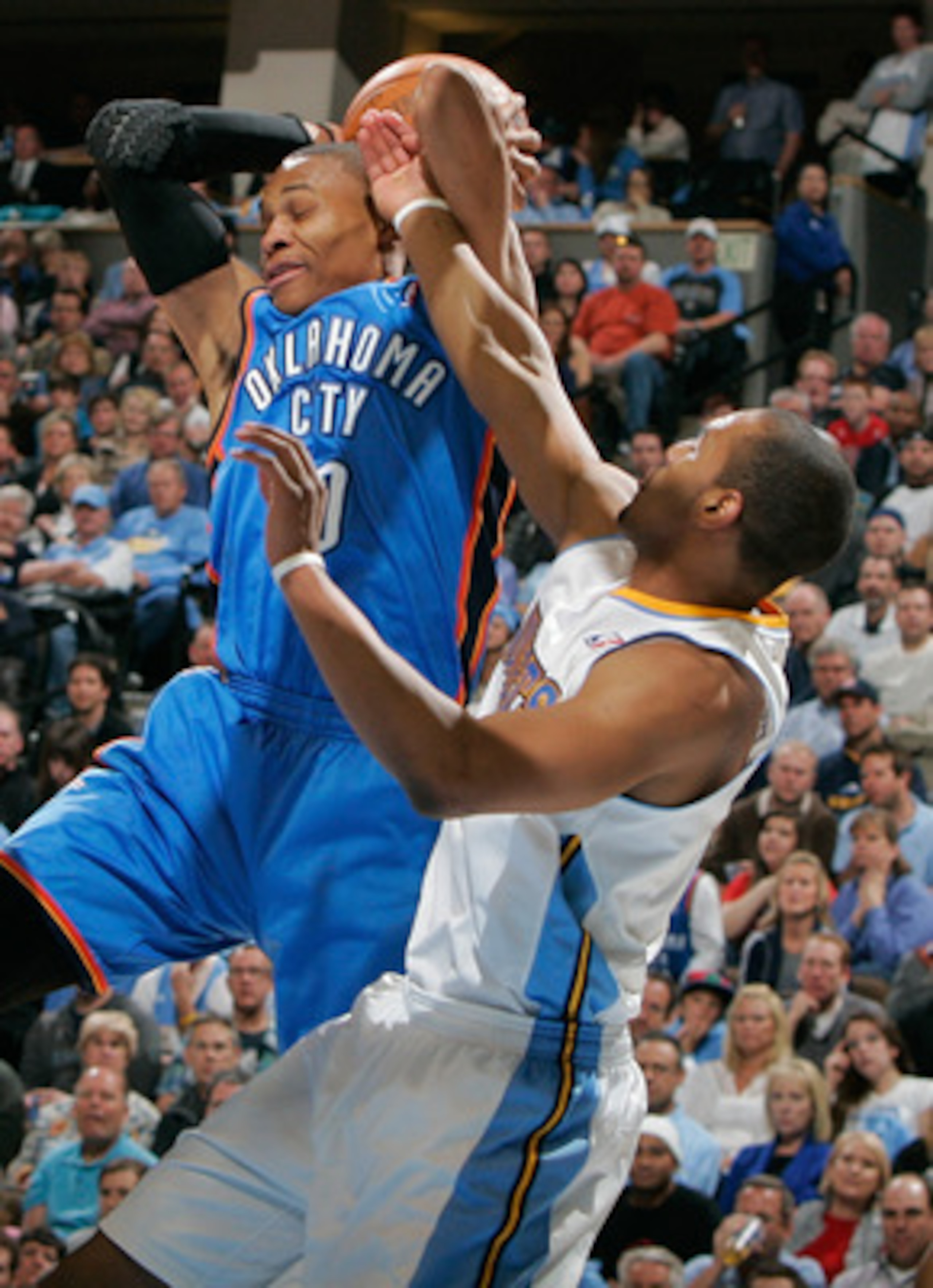 DENVER, CO - APRIL 23:  Russell Westbrook #0 of the Oklahoma City Thunder is fouled by Arron Afflalo #6 of the Denver Nuggets in Game Three of the Western Conference Quarterfinals in the 2011 NBA Playoffs at Pepsi Center on April 23, 2011 in Denver, Color
