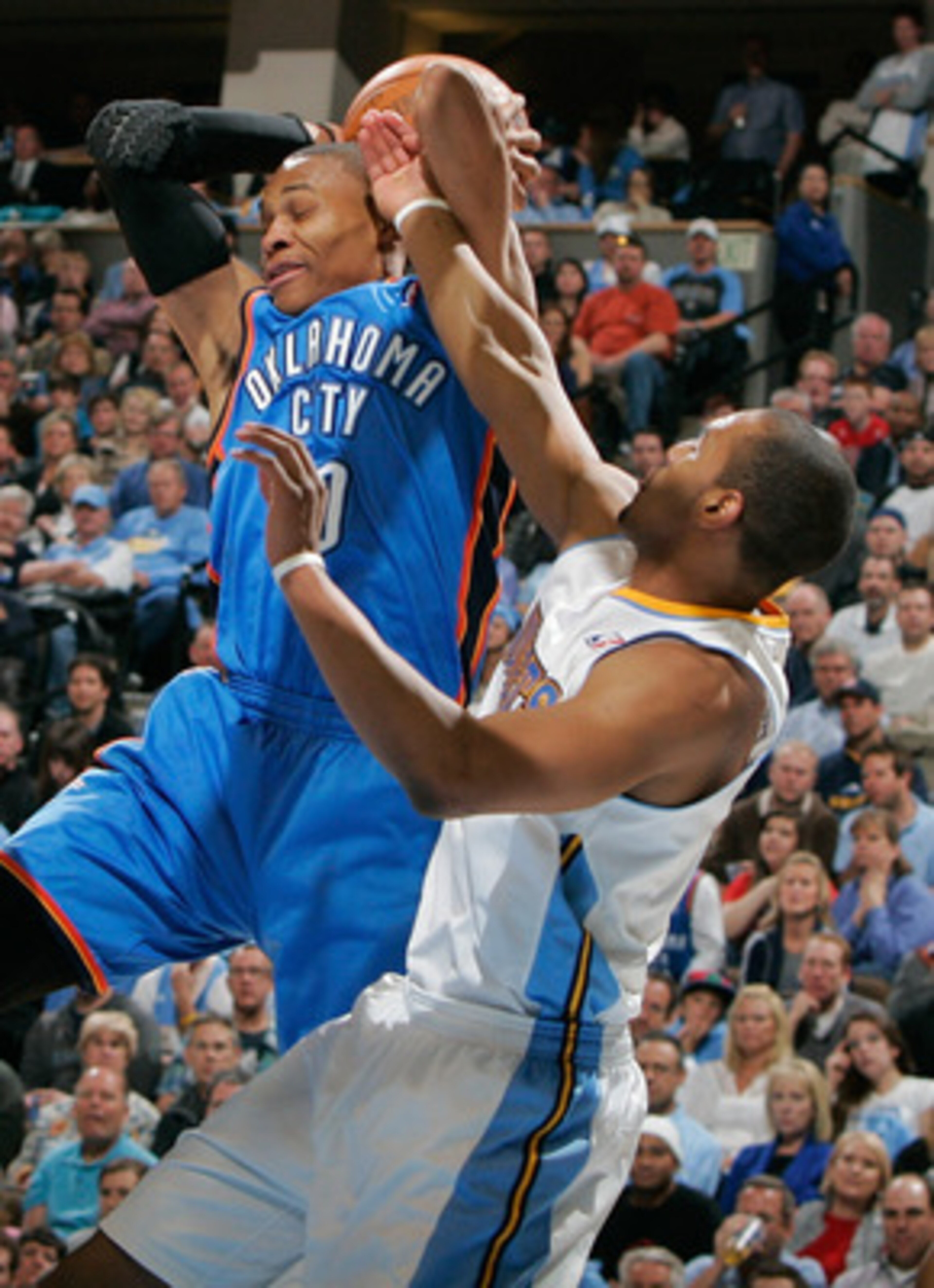 DENVER, CO - APRIL 23:  Russell Westbrook #0 of the Oklahoma City Thunder is fouled by Arron Afflalo #6 of the Denver Nuggets in Game Three of the Western Conference Quarterfinals in the 2011 NBA Playoffs at Pepsi Center on April 23, 2011 in Denver, Color
