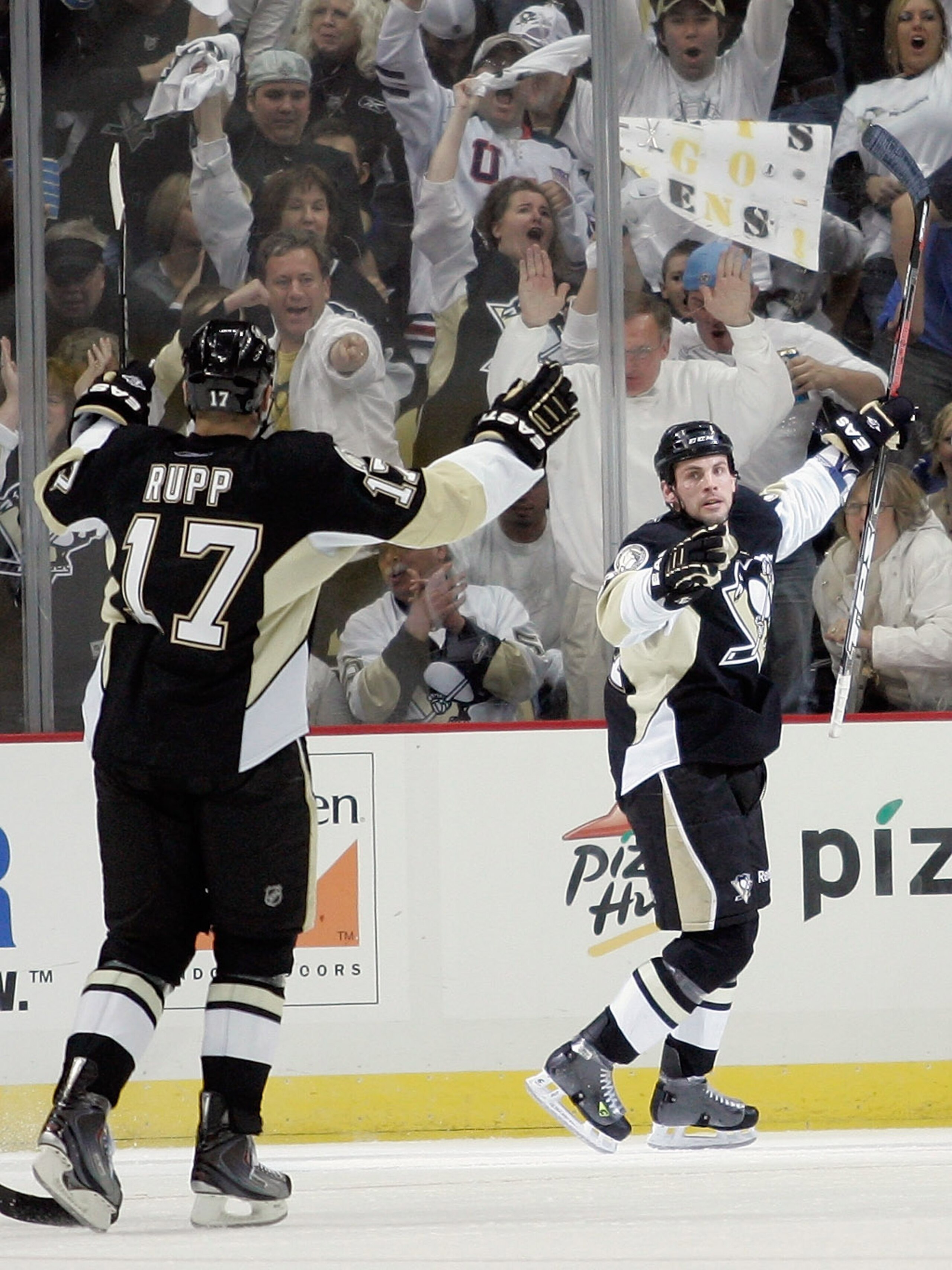 PITTSBURGH, PA - APRIL 15:  Craig Adams #27 (R) and Michael Rupp #17 of the Pittsburgh Penguins celebrate after Adams scored a second period goal against the Tampa Bay Lightning during Game Two of the Eastern Conference Quarterfinals during the 2011 NHL S