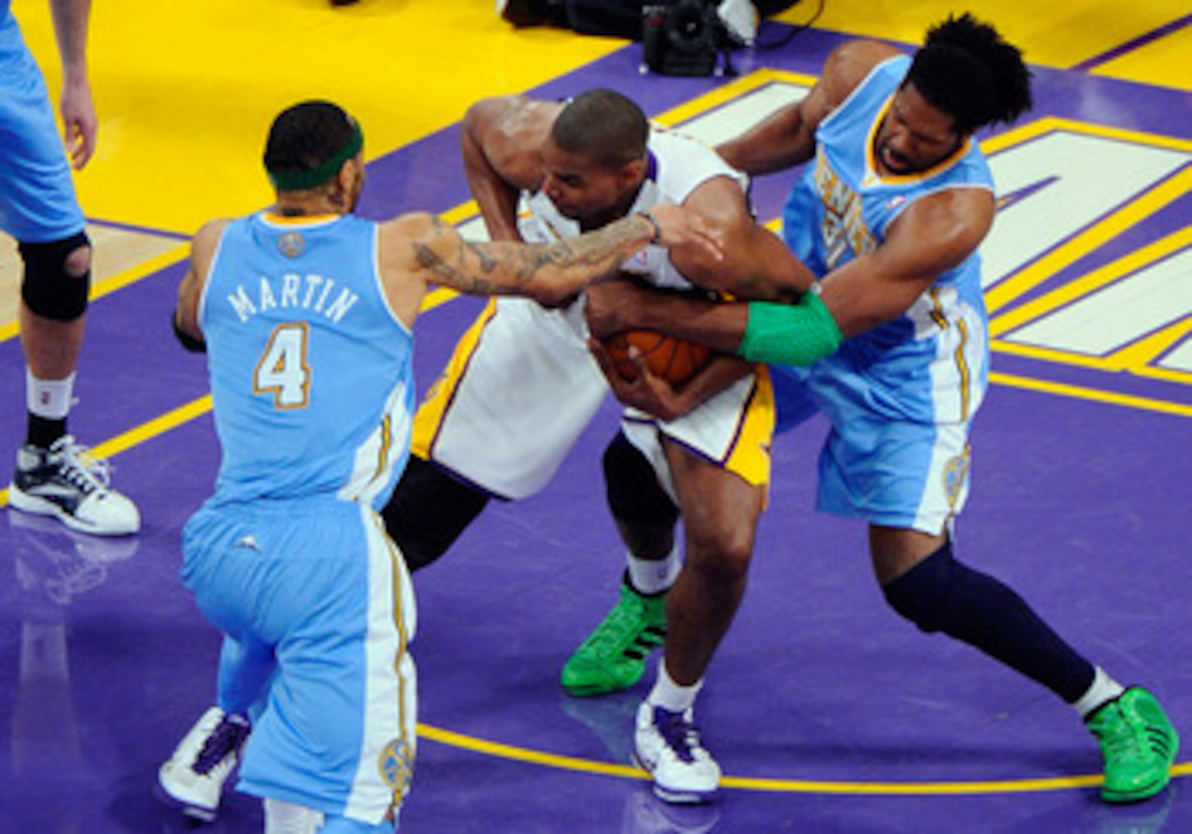 LOS ANGELES, CA - APRIL 03:  Kenyon Martin #4 and Nene #31 of the Denver Nuggets surround Andrew Bynum #17 of the Los Angeles Lakers during the game at Staples Center on April 3, 2011 in Los Angeles, California. NOTE TO USER: User expressly acknowledges a