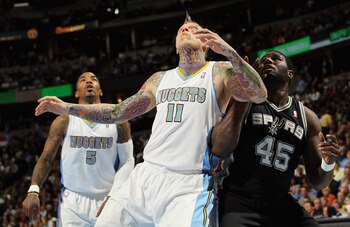 DENVER, CO - MARCH 23:  Chris Andersen #11 of the Denver Nuggets battle for position with DeJuan Blair #45 of the San Antonio Spurs at the Pepsi Center on March 23, 2011 in Denver, Colorado. The Nuggets defeated the Spurs 115-112. NOTE TO USER: User expre