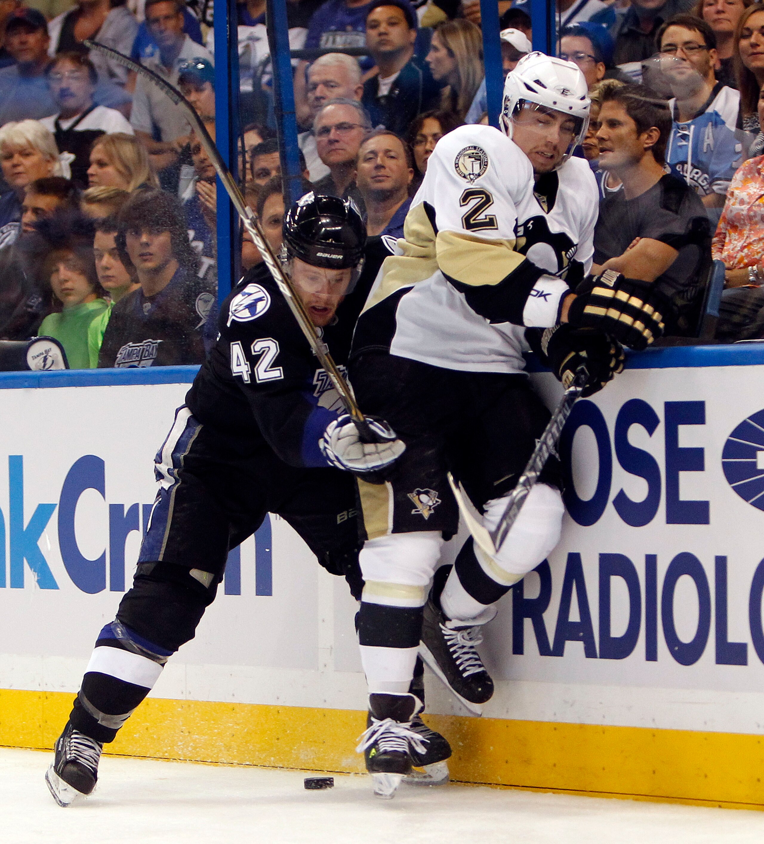 TAMPA, FL - APRIL 18: Dana Tyrell #42 of the Tampa Bay Lightning collides with Matt Niskanen #2 of the Pittsburgh Penguins in Game Three of the Eastern Conference Quarterfinals during the 2011 NHL Stanley Cup Playoffs at the St. Pete Times Forum on April