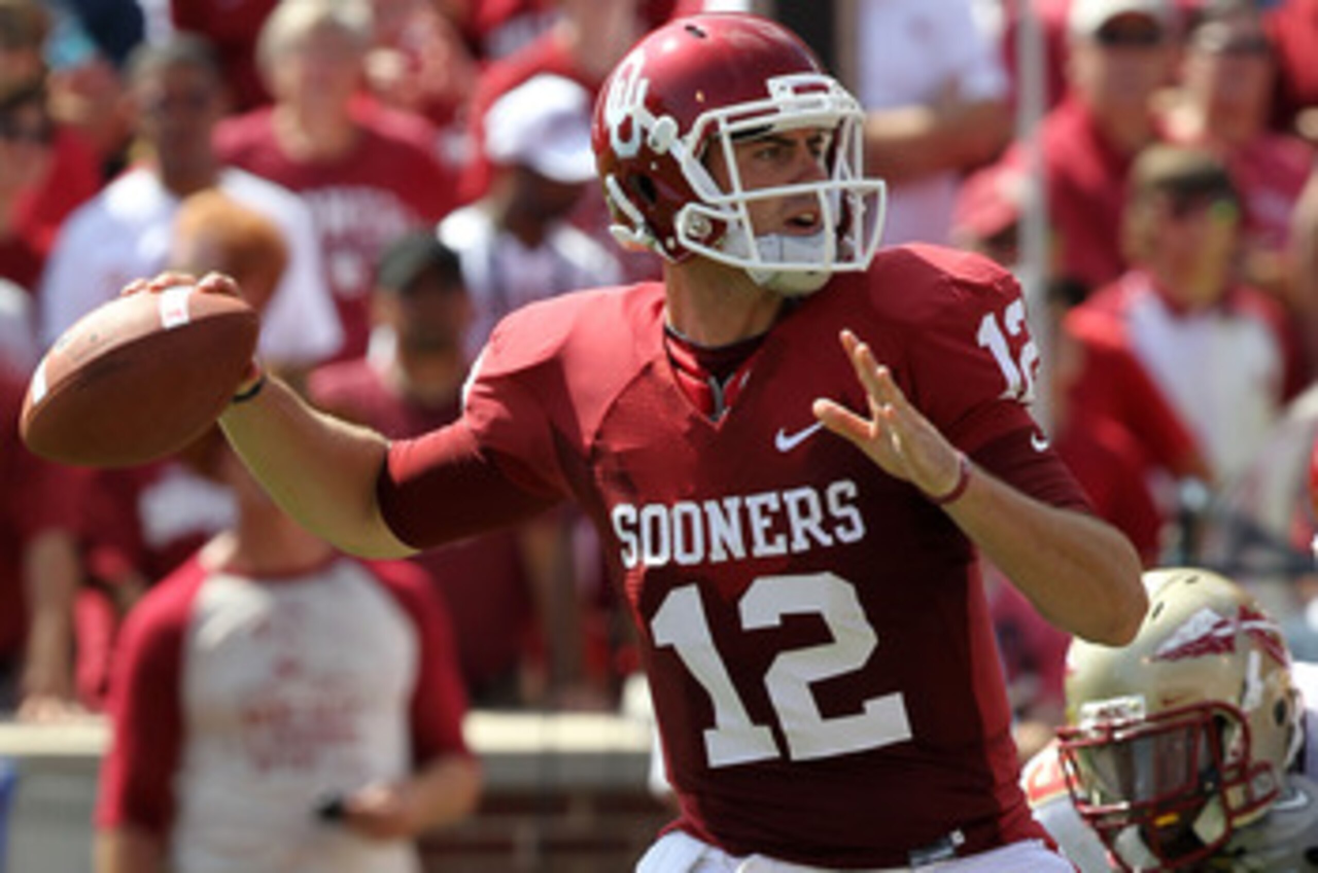 NORMAN, OK - SEPTEMBER 11:  Quarterback Landry Jones #12 of the Oklahoma Sooners drops back to pass against the Florida State Seminoles in the first quarter at Gaylord Family Oklahoma Memorial Stadium on September 11, 2010 in Norman, Oklahoma.  (Photo by