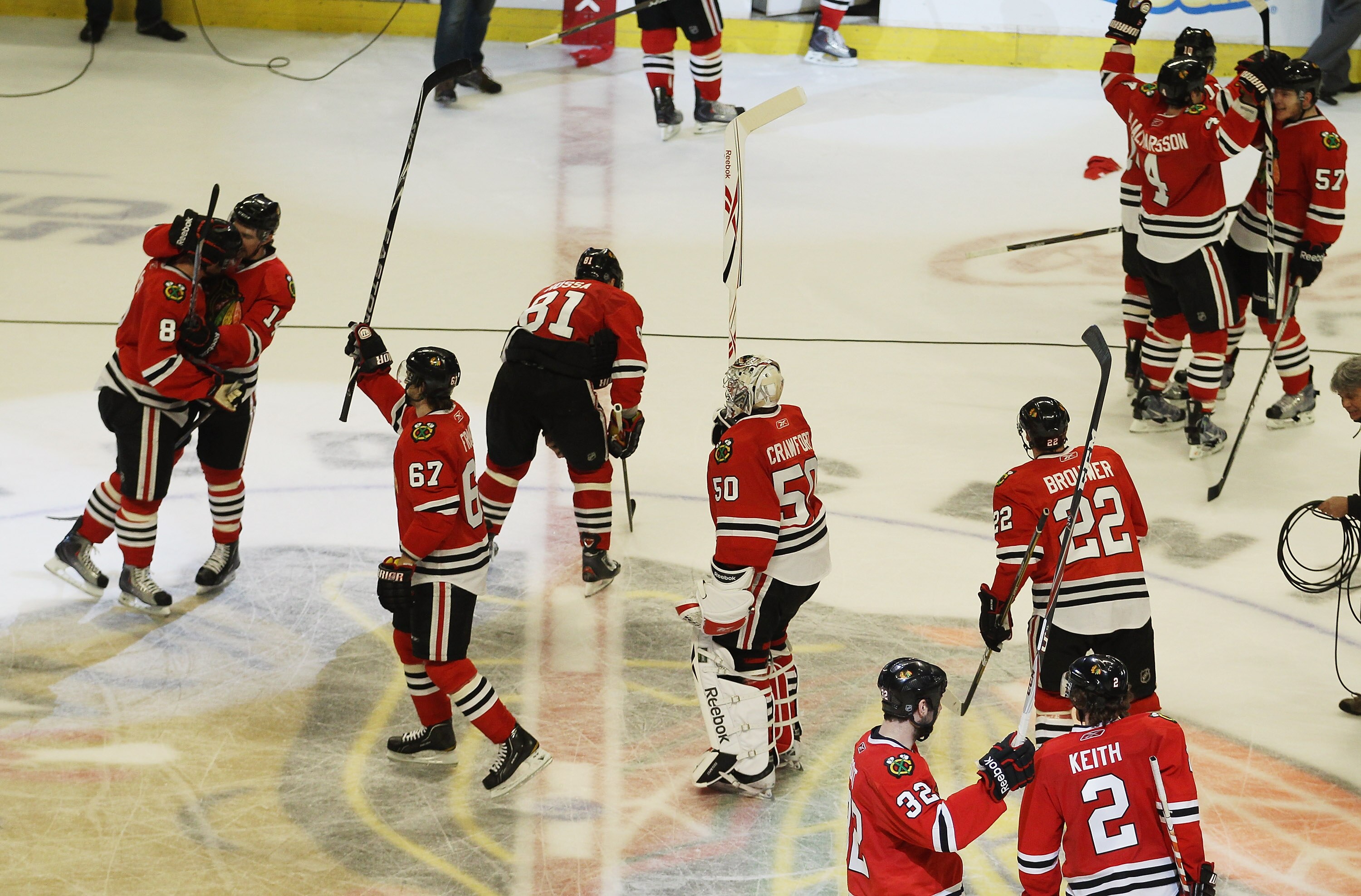 CHICAGO, IL - APRIL 24: Members of the Chicago Blackhawks including Corey Crawford #50 salute the crowd and celebrate a win over the Vancouver Canucks in Game Six of the Western Conference Quarterfinals during the 2011 NHL Stanley Cup Playoffs at the Unit
