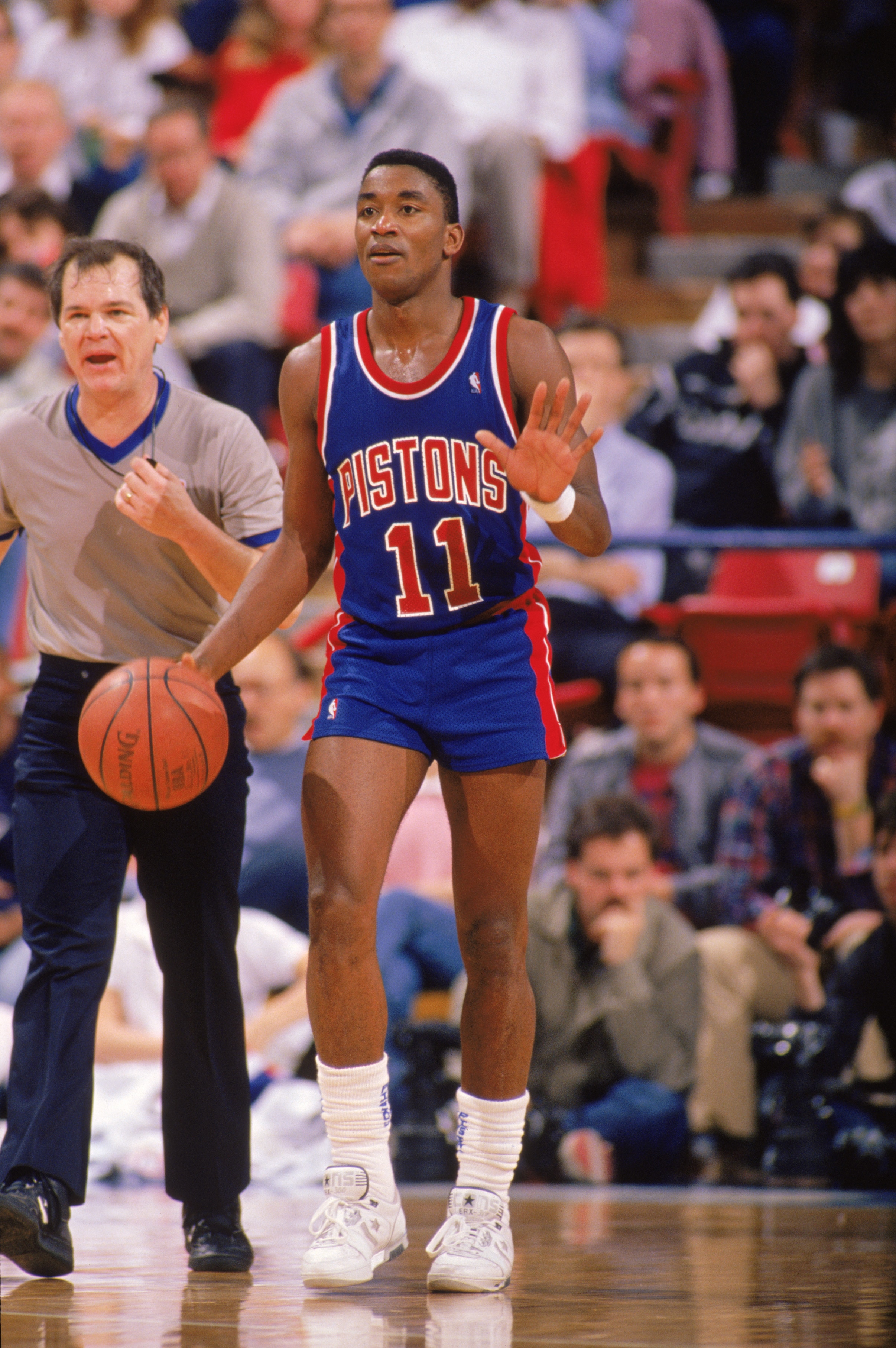 1989:  Isiah Thomas #11 of the Detroit Pistons advances the ball during a game in the 1988-1989 NBA season.   (Photo by Tim Defrisco/Getty Images)