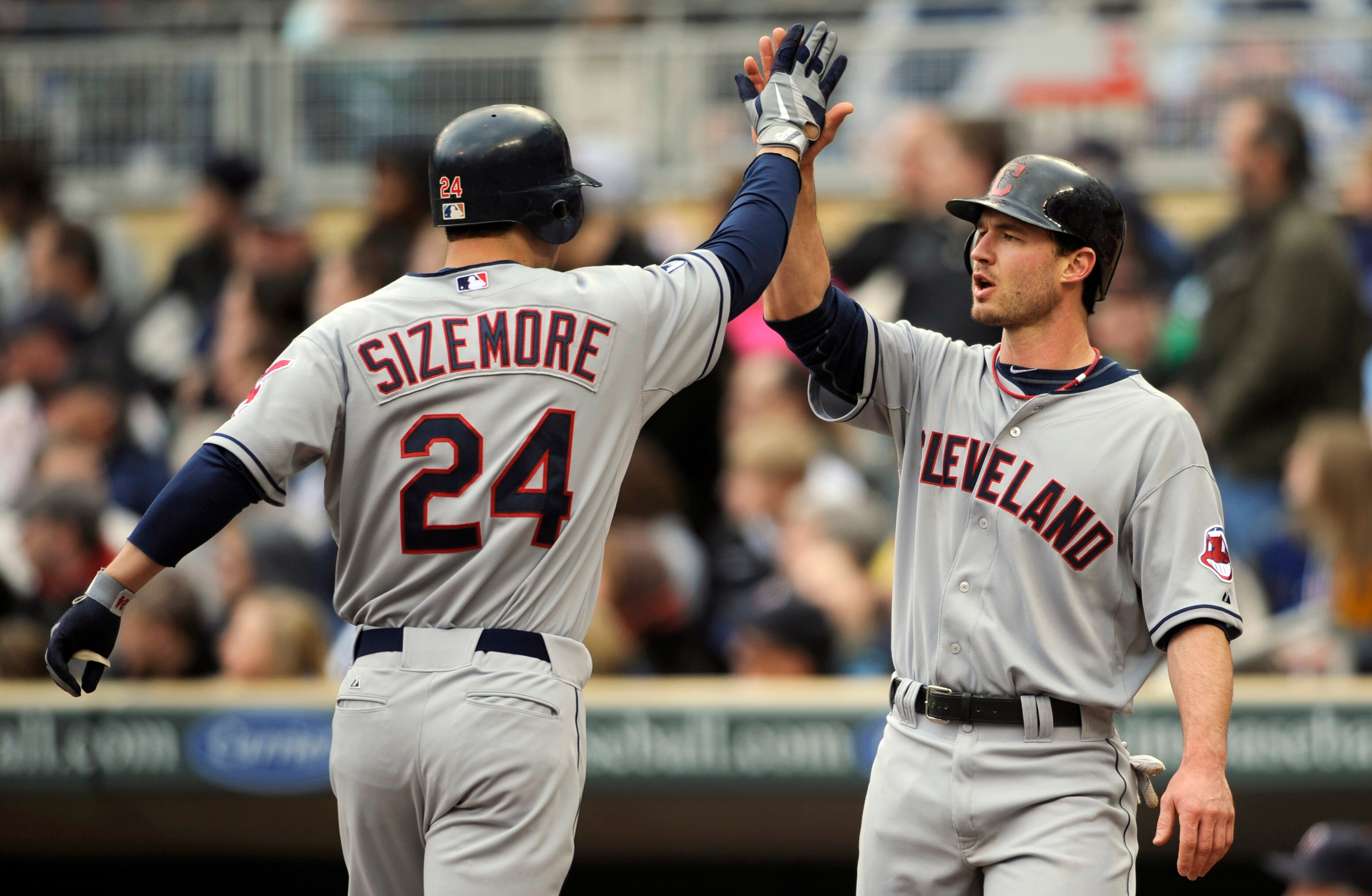 MINNEAPOLIS, MN - APRIL 23: Grady Sizemore #24 and Jack Hannahan #9 of the Cleveland Indians celebrate a two-run home run by Sizemore against the Minnesota Twins during the eighth inning of their game on April 23, 2011 at Target Field in Minneapolis, Minn