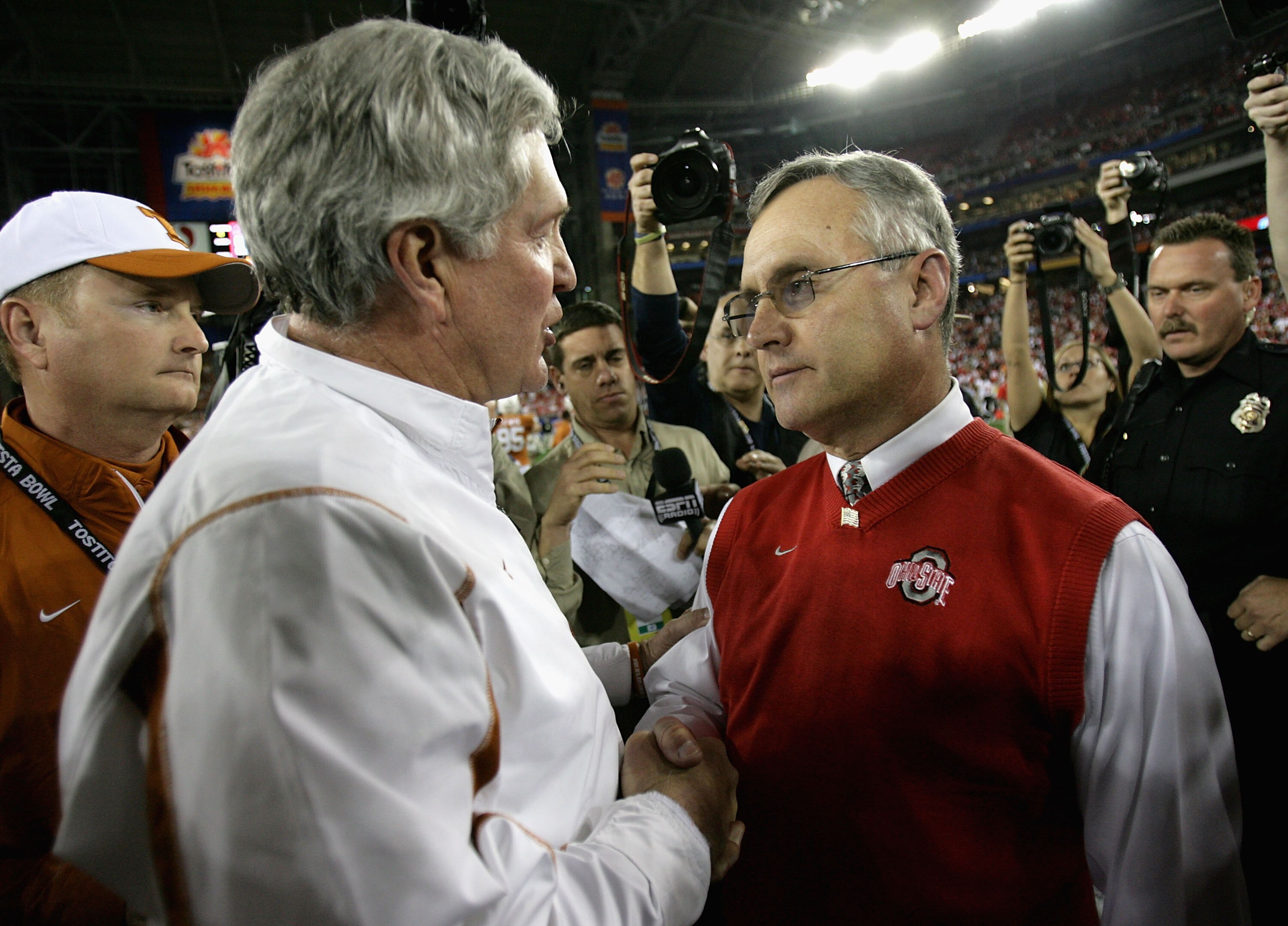 GLENDALE, AZ - JANUARY 05:  Head coach Jim Tressel of the Ohio State Buckeyes greets  Mack Brown of the Texas Longhorns after the Tostitos Fiesta Bowl Game on January 5, 2009 at University of Phoenix Stadium in Glendale, Arizona. The Longhorns defeated th