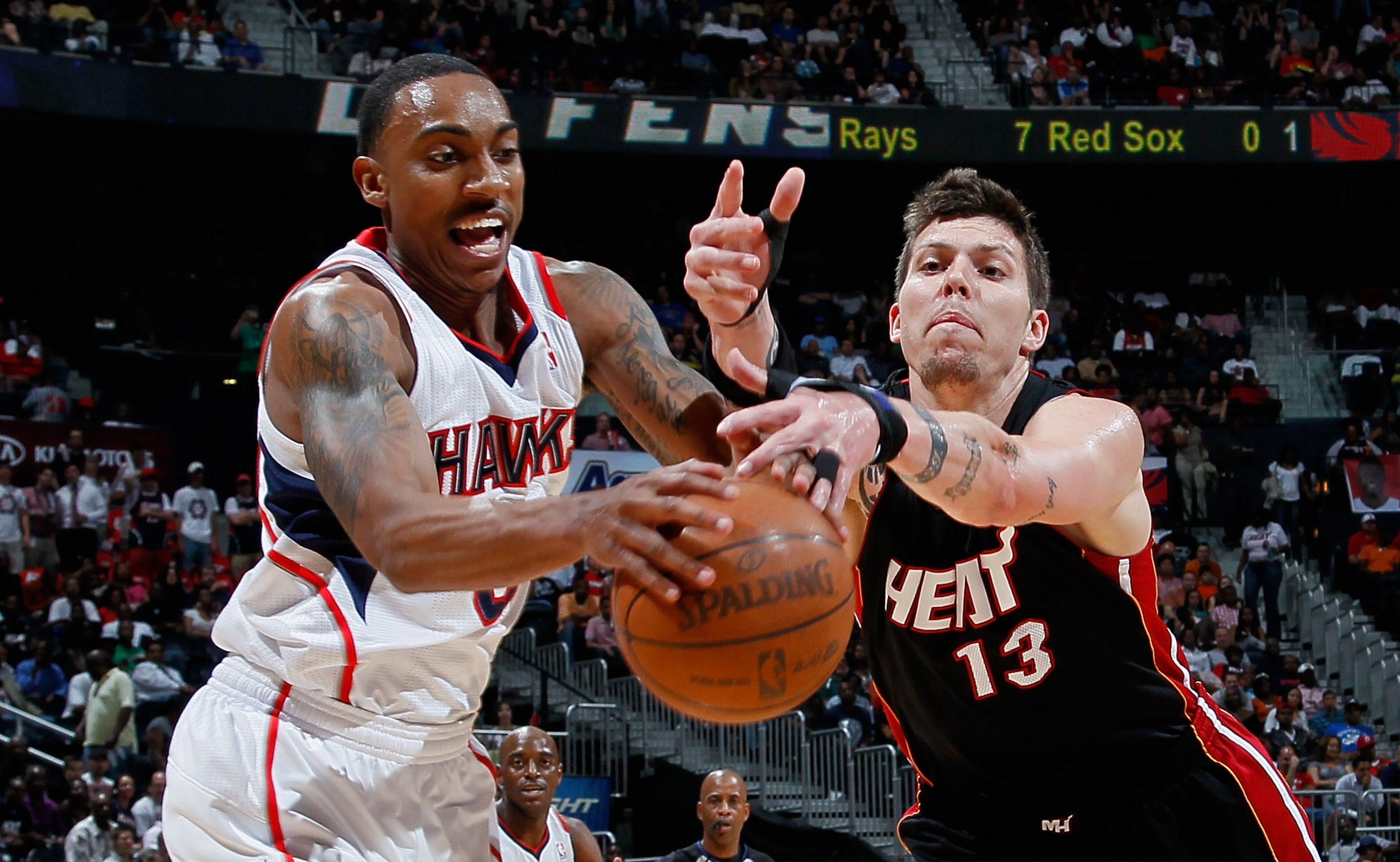 ATLANTA, GA - APRIL 11:  Mike Miller #13 of the Miami Heat battles for a loose ball against Jeff Teague #0 of the Atlanta Hawks at Philips Arena on April 11, 2011 in Atlanta, Georgia.  NOTE TO USER: User expressly acknowledges and agrees that, by download