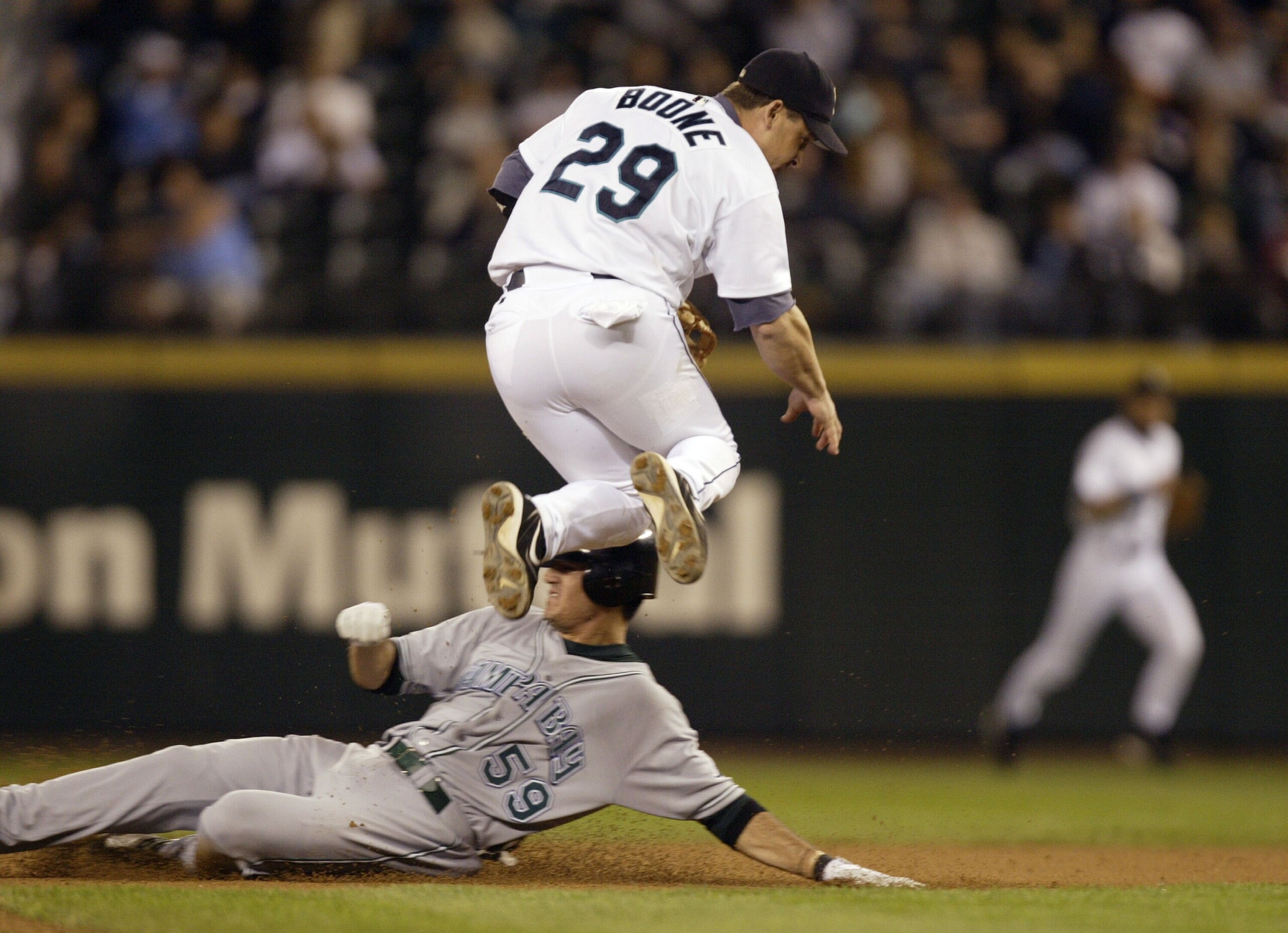 SEATTLE - AUGUST 25:  Bret Boone #29 of the Seattle Mariners turns a double play over Jorge Cantu #59 of the Tampa Bay Devil Rays in the sixth inning on August 25, 2004 at Safeco Field in Seattle, Washington. The Devil Rays defeated the Mariners 6-5.  (Ph