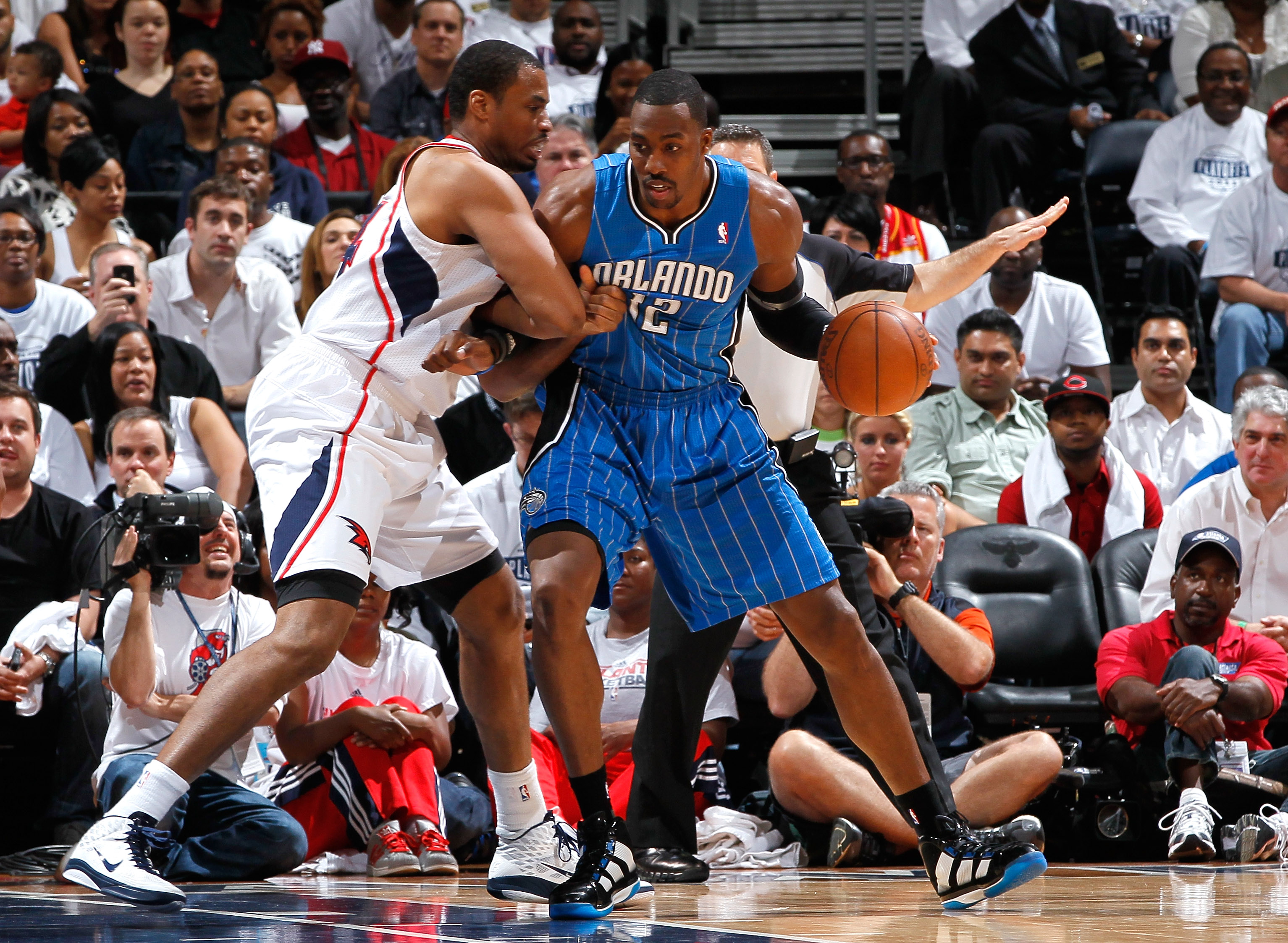 ATLANTA, GA - APRIL 22:  Dwight Howard #12 of the Orlando Magic drives into the basket against Jason Collins #34 of the Atlanta Hawks during Game Three of the Eastern Conference Quarterfinals in the 2011 NBA Playoffs at Philips Arena on April 22, 2011 in