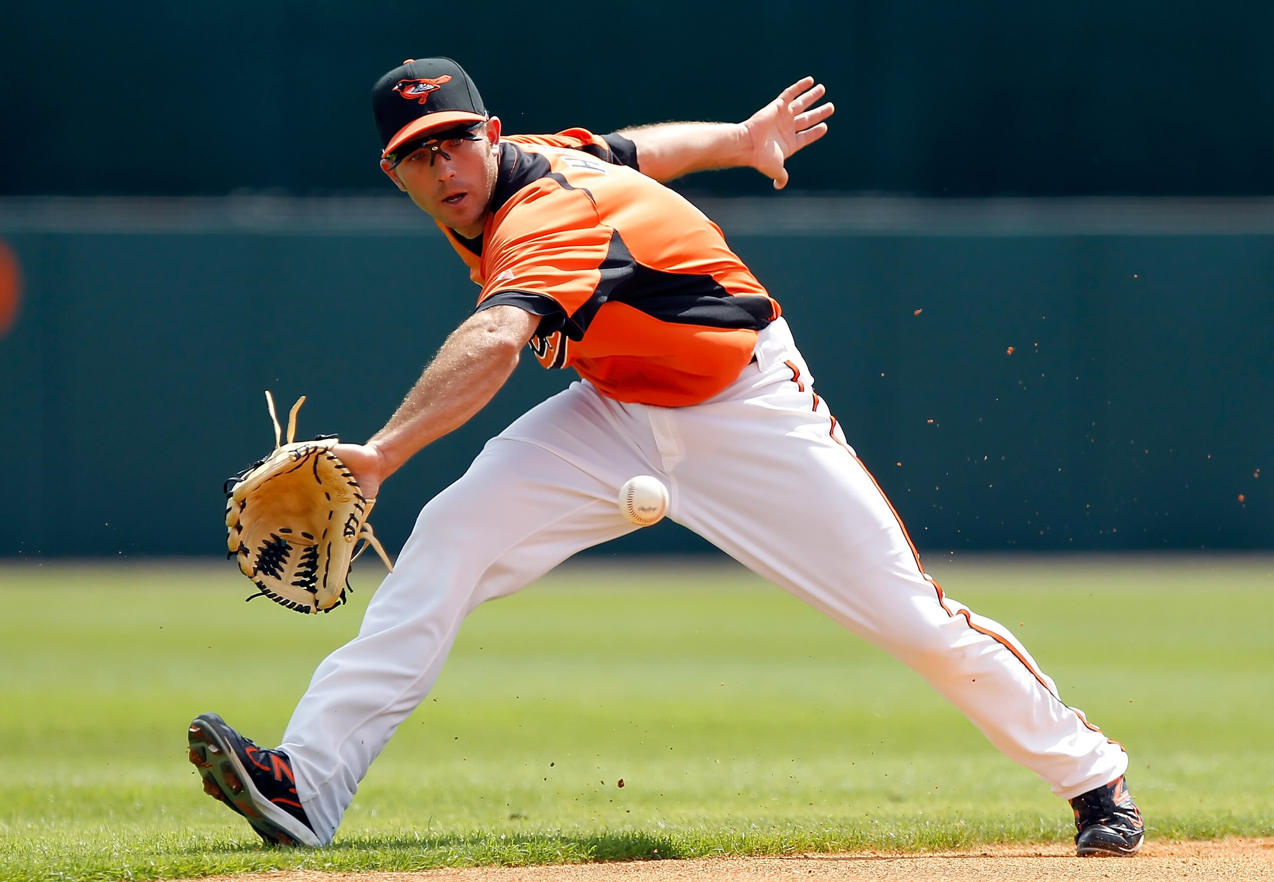 SARASOTA, FL - MARCH 05: Shortstop J.J. Hardy #2 of the Baltimore Orioles just gets to this ground ball in the first inning against the Boston Red Sox during a Grapefruit League Spring Training Game at Ed Smith Stadium on March 5, 2011 in Sarasota, Flori SARASOTA, FL - MARCH 05: Shortstop J.J. Hardy #2 of the Baltimore Orioles just gets to this ground ball in the first inning against the Boston Red Sox during a Grapefruit League Spring Training Game at Ed Smith Stadium on March 5, 2011 in Sarasota, Flori