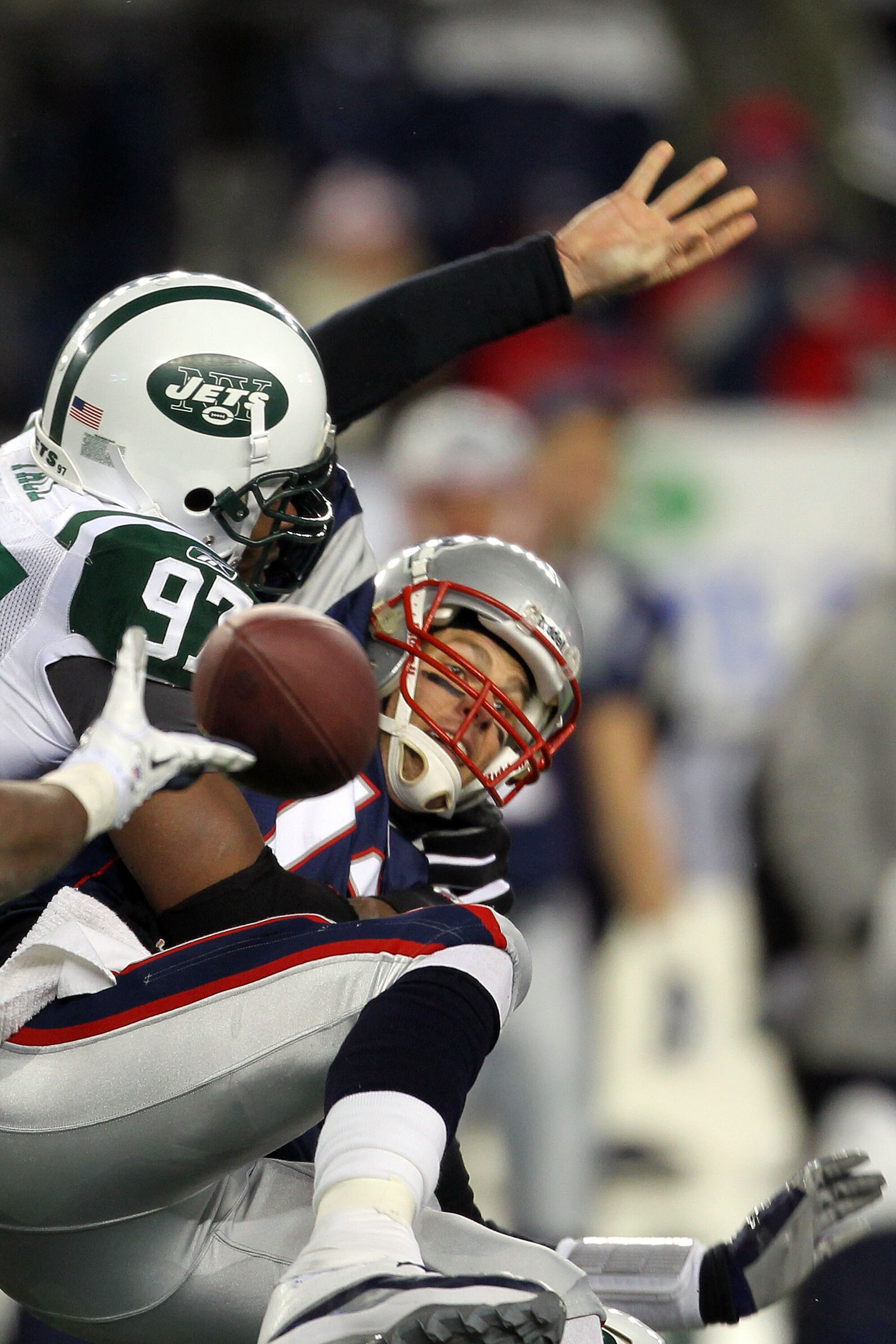 FOXBORO, MA - JANUARY 16:  Tom Brady #12 of the New England Patriots looses the ball as he is sacked by Calvin Pace #97 of the New York Jets in the third quarter of their 2011 AFC divisional playoff game at Gillette Stadium on January 16, 2011 in Foxboro,