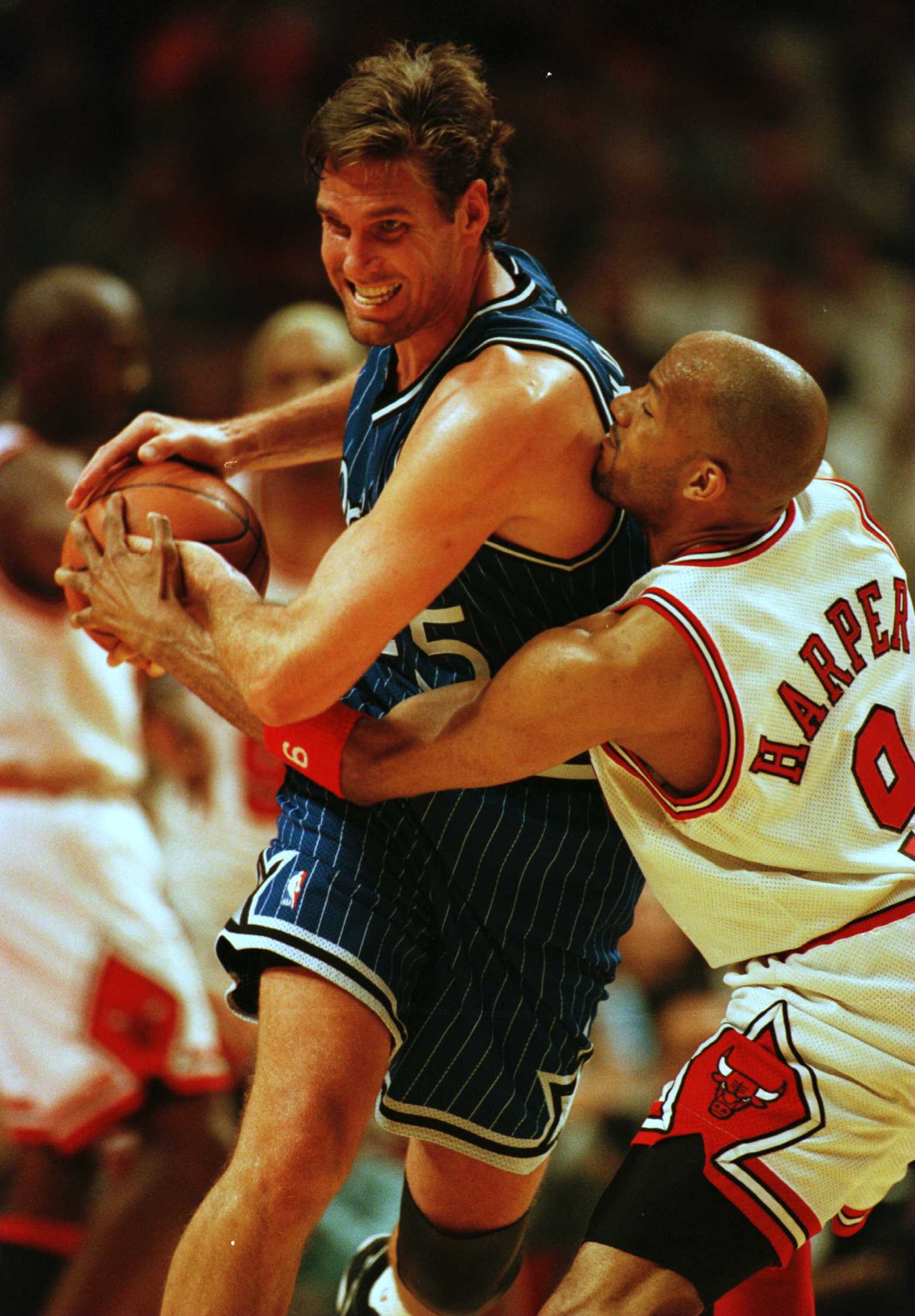 21 May 1996: Guard Ron Harper of the Chicago Bulls reaches for the ball on Forward Jon Koncak of the Orlando Magic during third quarter action of game two of the Eastern Conference Championship at the United Center in Chicago, Illinois. Mandatory Credit: