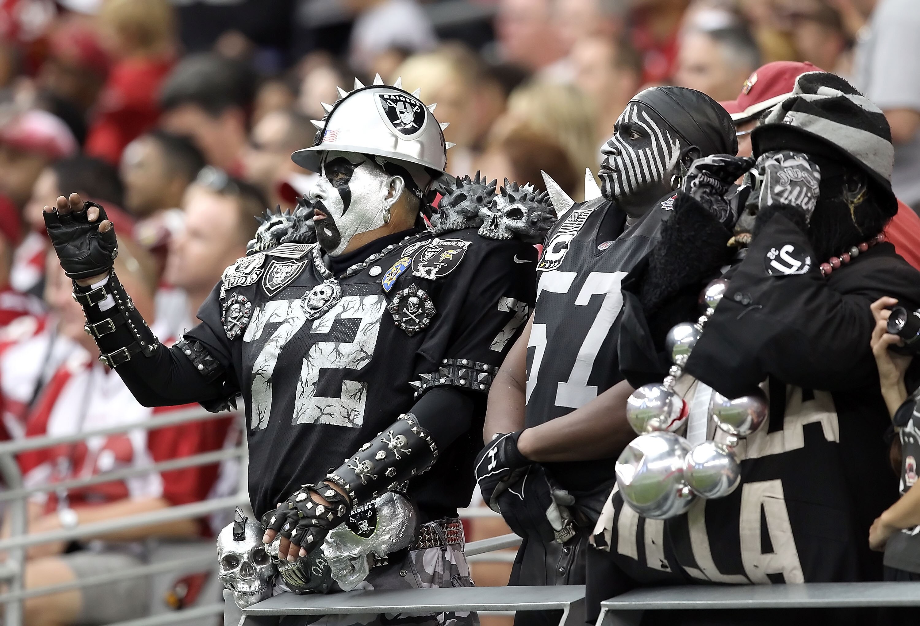 GLENDALE, AZ - SEPTEMBER 26:  Fans of the Oakland Raiders cheer during the NFL game against the Arizona Cardinals at the University of Phoenix Stadium on September 26, 2010 in Glendale, Arizona. The Cardinals defeated the Raiders 24-23.   (Photo by Christ