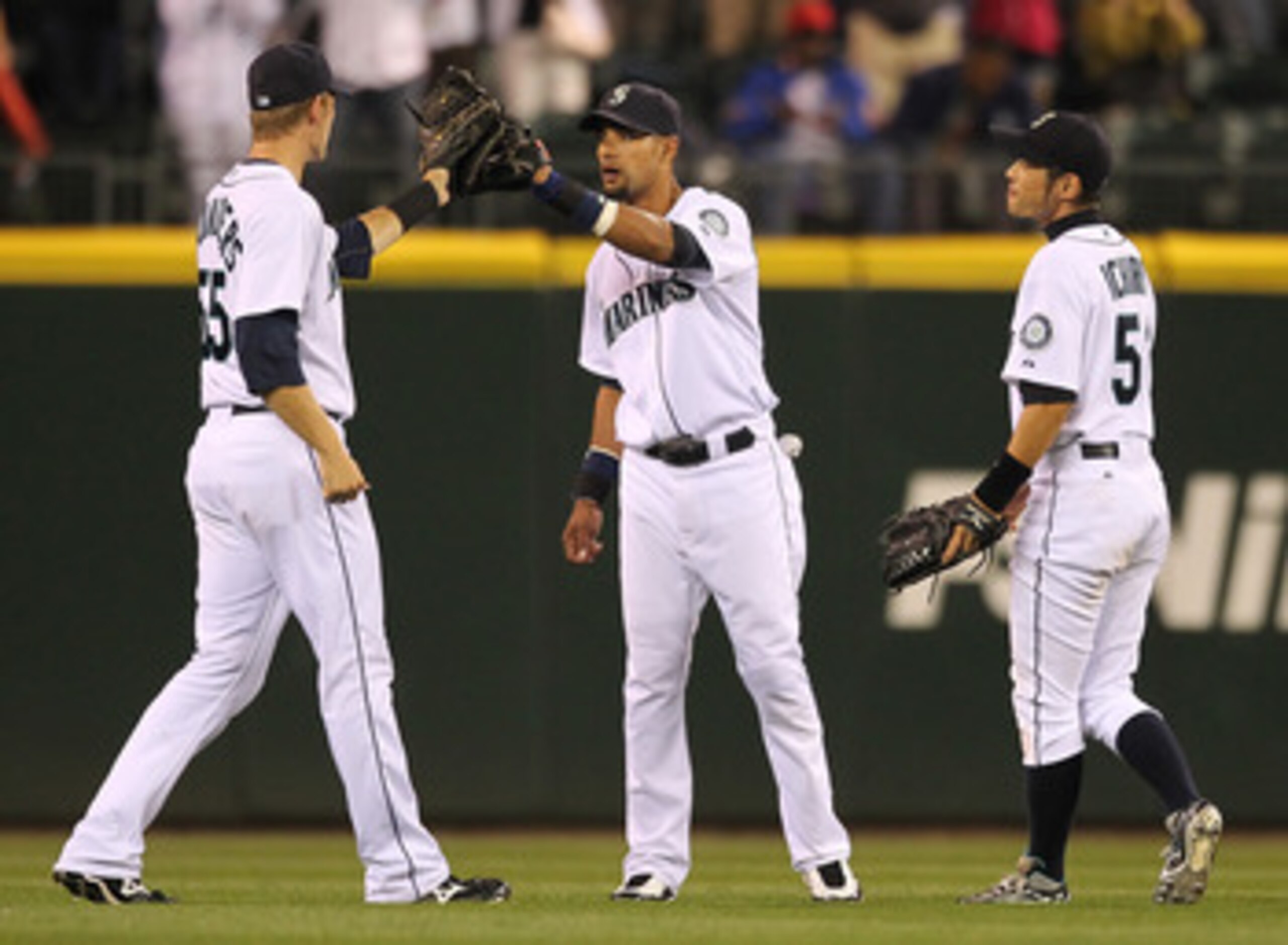 SEATTLE - AUGUST 03:  (L-R) Outfielders Michael Saunders #55, Franklin Gutierrez #21, and Ichiro Suzuki #51 of the Seattle Mariners celebrate after defeating the Texas Rangers 3-2 at Safeco Field on August 3, 2010 in Seattle, Washington. (Photo by Otto Gr