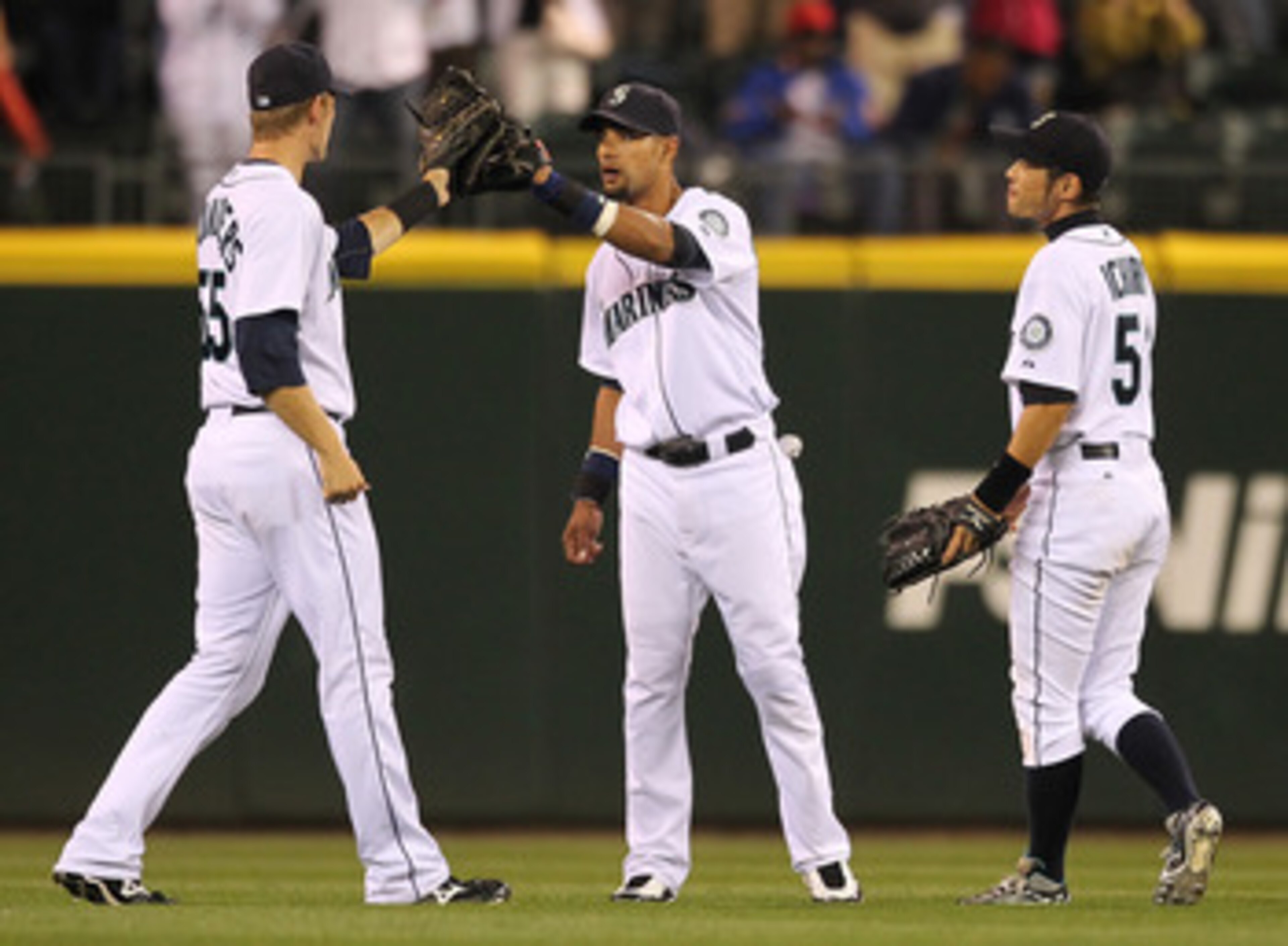 SEATTLE - AUGUST 03:  (L-R) Outfielders Michael Saunders #55, Franklin Gutierrez #21, and Ichiro Suzuki #51 of the Seattle Mariners celebrate after defeating the Texas Rangers 3-2 at Safeco Field on August 3, 2010 in Seattle, Washington. (Photo by Otto Gr