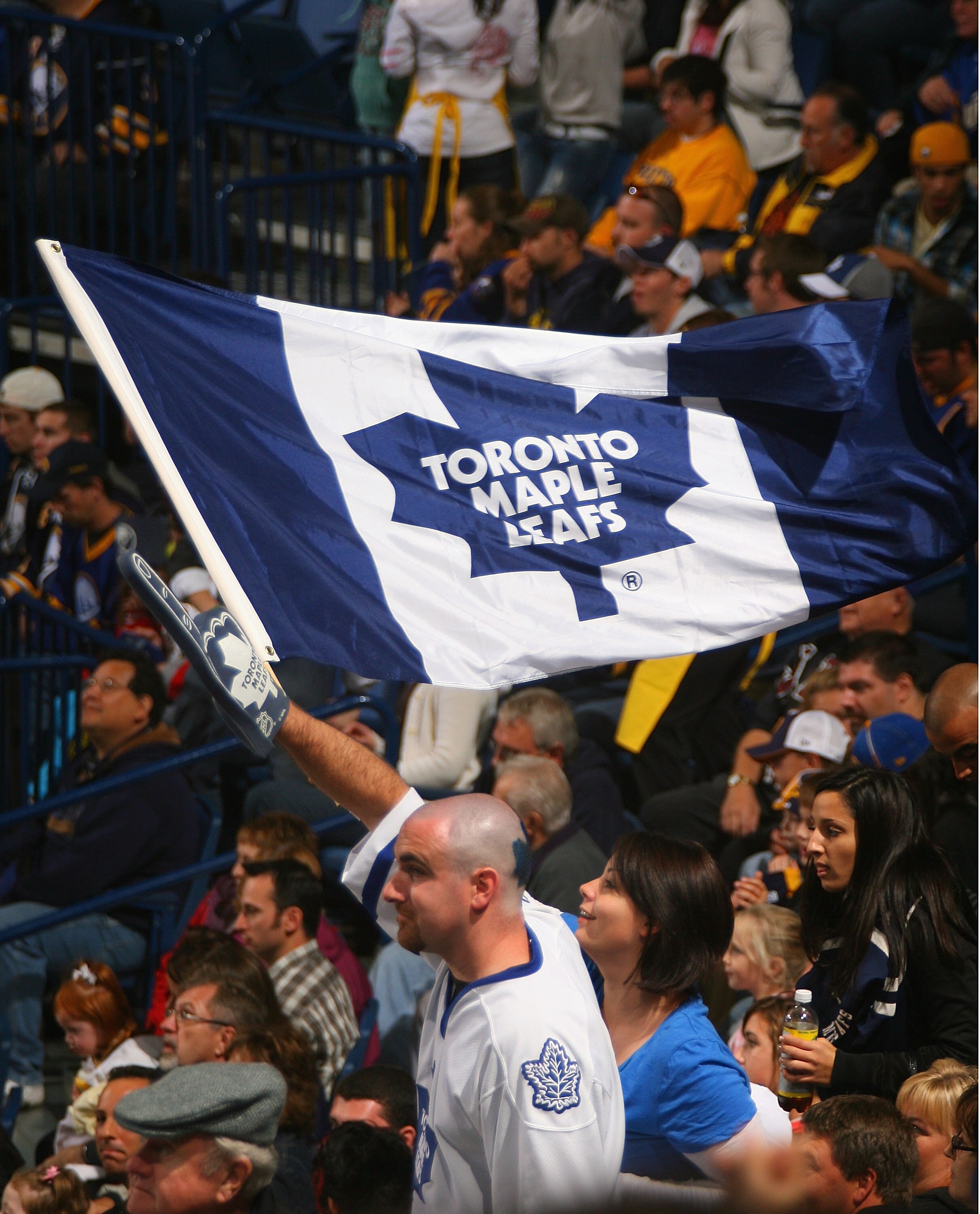 BUFFALO, NY - SEPTEMBER 25: Fans of the Toronto Maple Leafs wave a Maple Leaf flag while playing the Buffalo Sabres  at HSBC Arena on September 25, 2010 in Buffalo, New York.  (Photo by Rick Stewart/Getty Images)