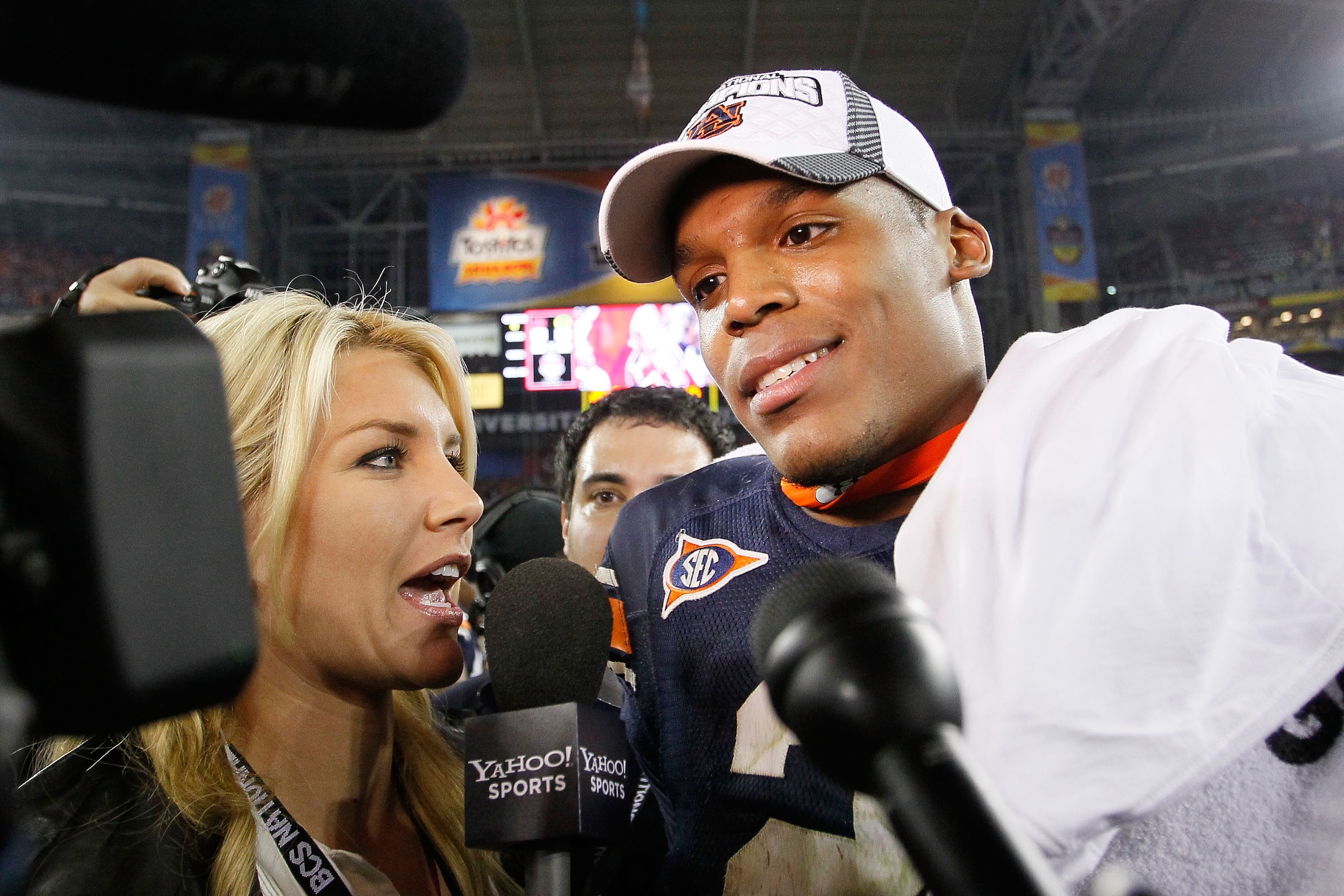 GLENDALE, AZ - JANUARY 10:  Quarterback Cameron Newton #2 of the Auburn Tigers talks with ESPN sideline reporter Erin Andrews as he celebrates the Tigers 22-19 victory against the Oregon Ducks in the Tostitos BCS National Championship Game at University o
