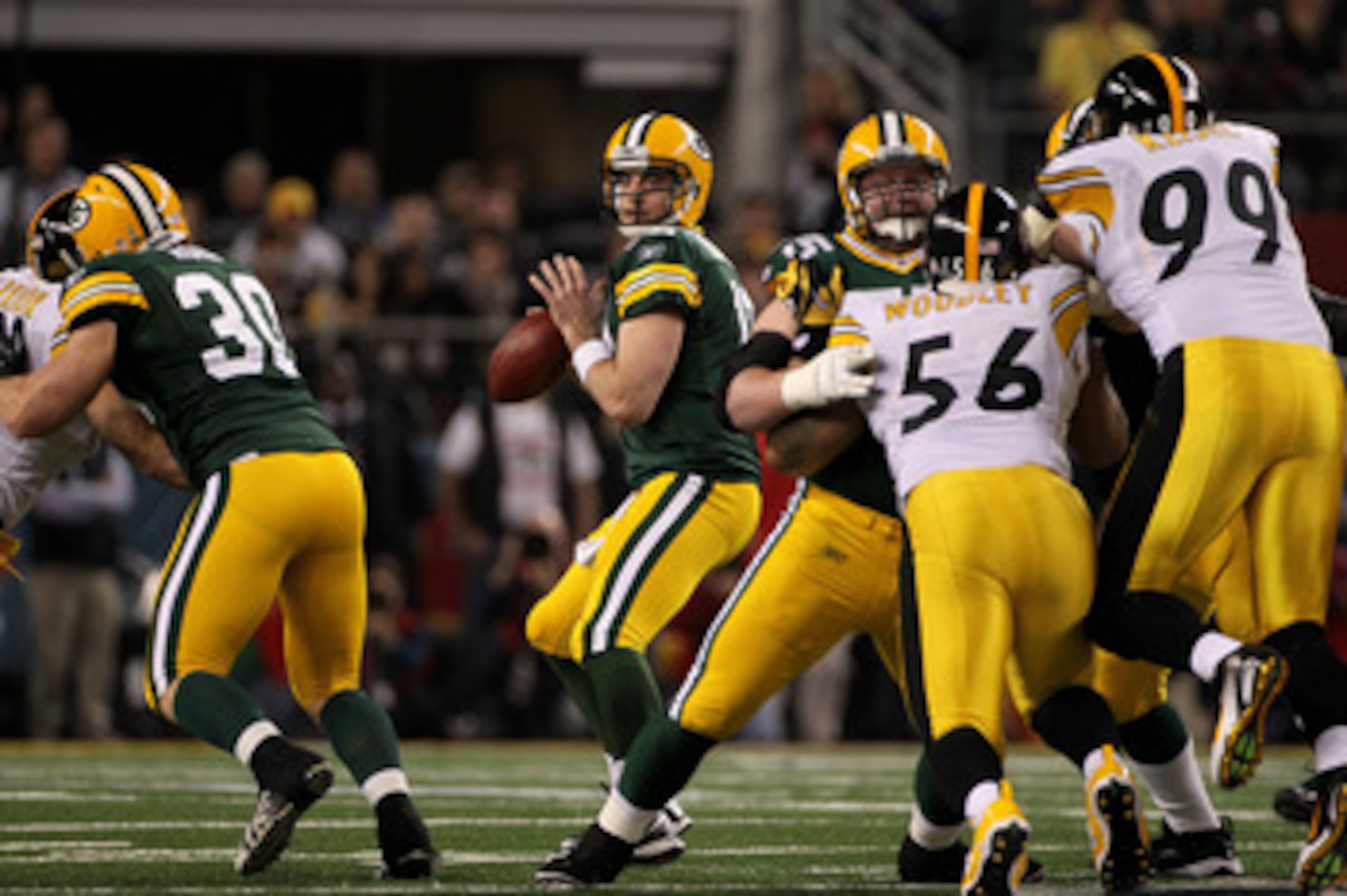 ARLINGTON, TX - FEBRUARY 06:  Aaron Rodgers #12 of the Green Bay Packers drops back against the Pittsburgh Steelers during the first quarter of Super Bowl XLV at Cowboys Stadium on February 6, 2011 in Arlington, Texas.  (Photo by Doug Pensinger/Getty Imag