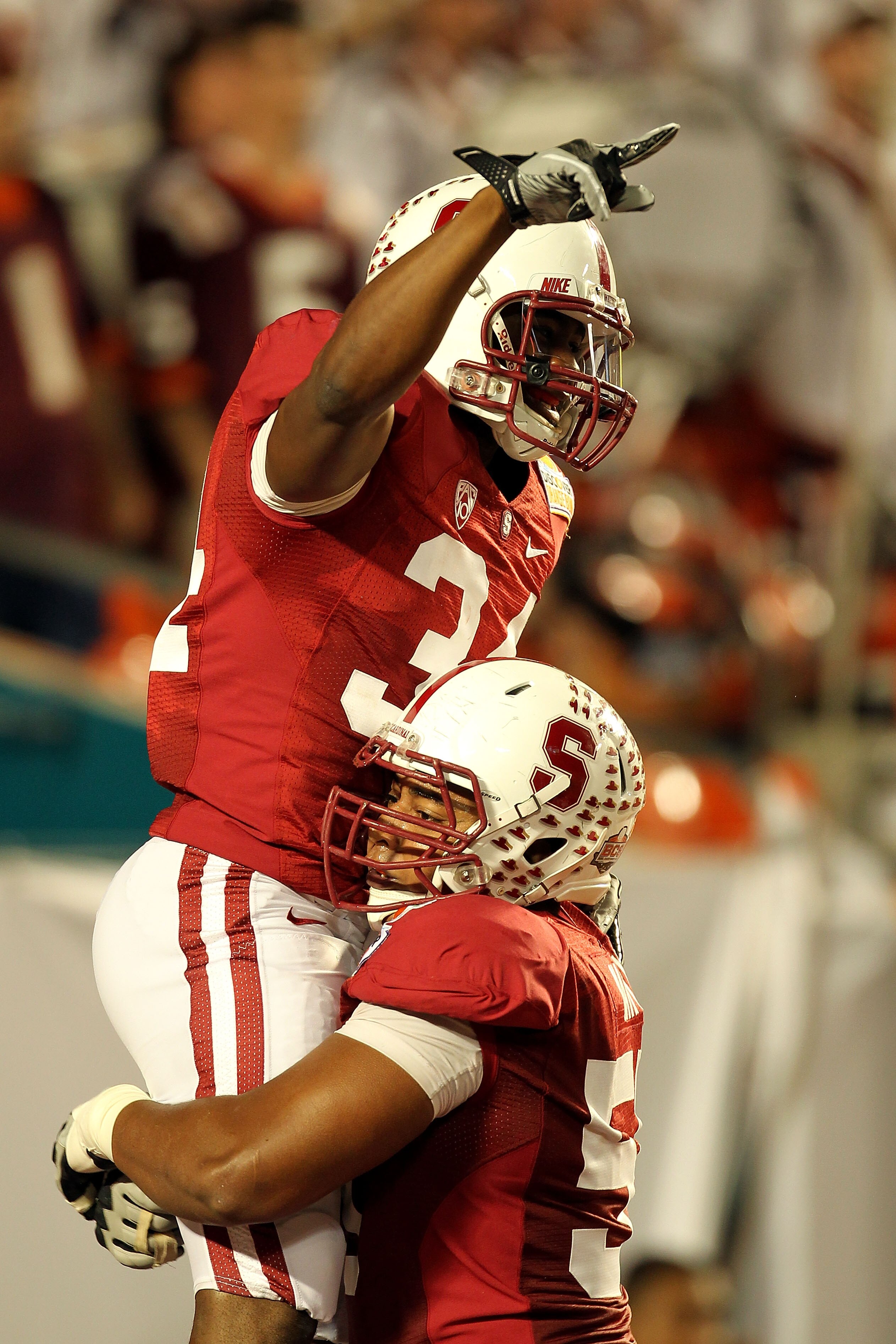 MIAMI, FL - JANUARY 03:  (L-R) Jeremy Stewart #34 and Jonathan Martin #55 of the Stanford Cardinal celebrate after Stewart scored a 60-yard rushing touchdown in the first quarter against the Virginai Tech Hokies during the 2011 Discover Orange Bowl at Sun