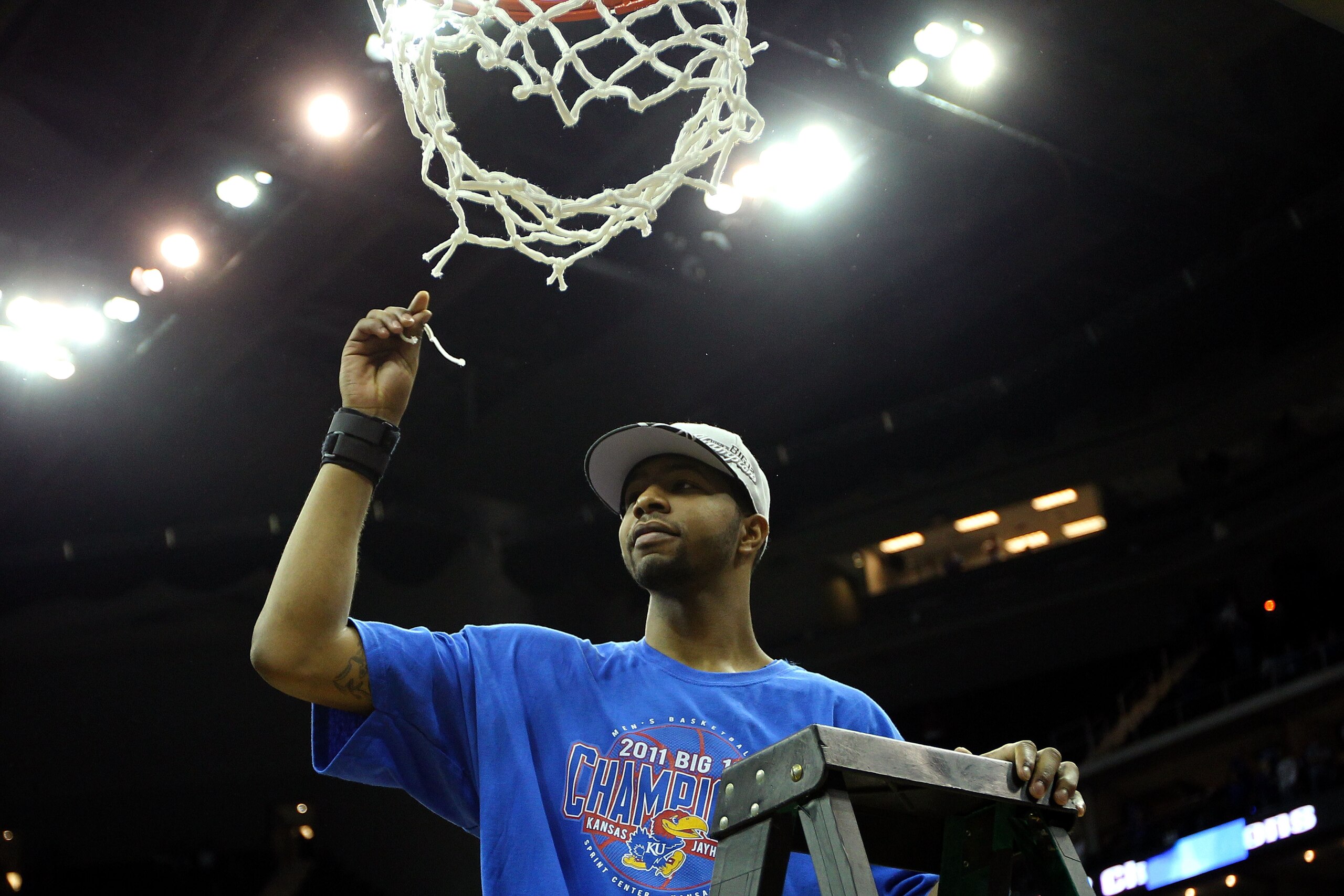 KANSAS CITY, MO - MARCH 12:  Markieff Morris #21 of the Kansas Jayhawks celebrates by cutting down the net after defeating the Texas Longhorns 85-73 to win the 2011 Phillips 66 Big 12 Men's Basketball Tournament championship game at Sprint Center on March
