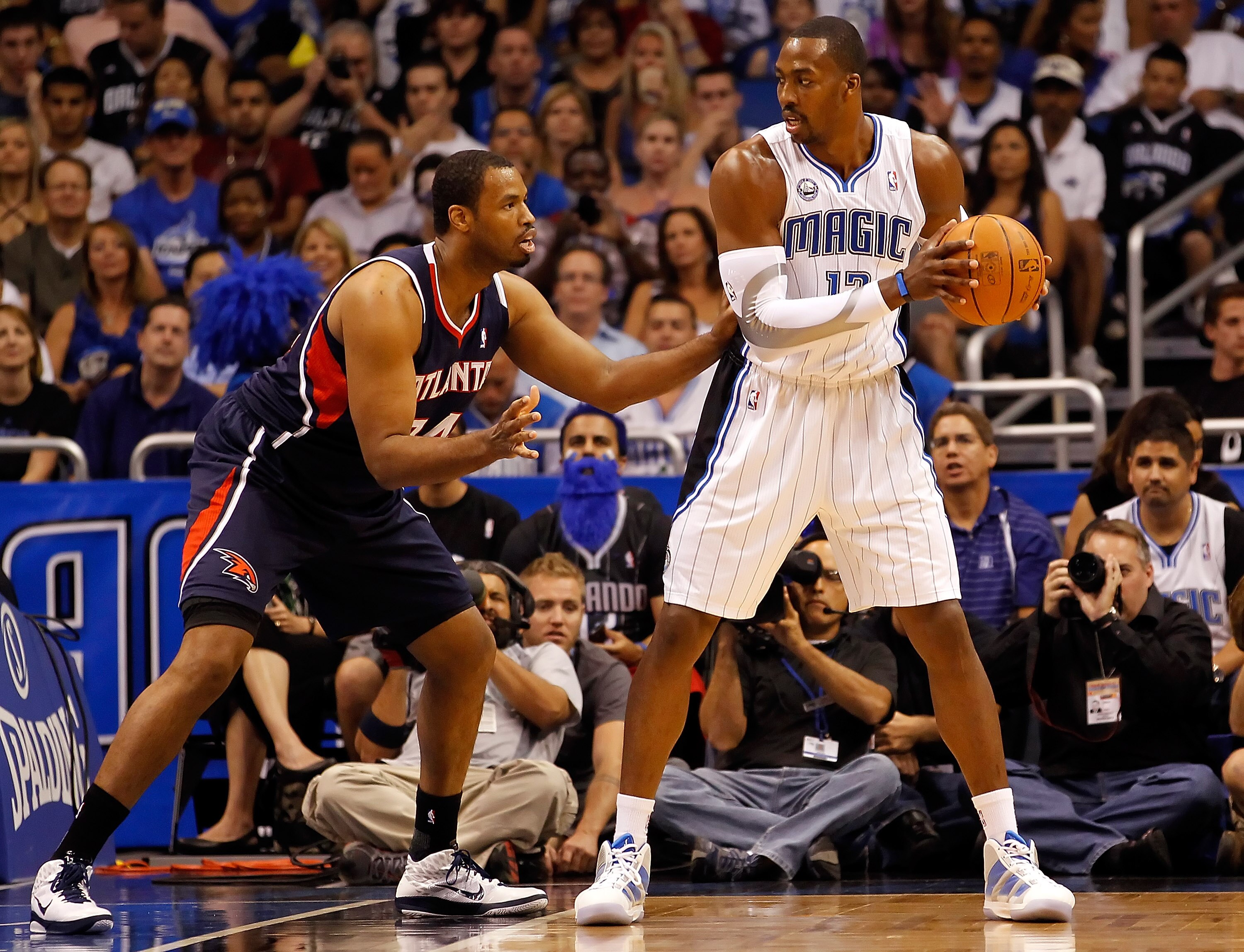 ORLANDO, FL - APRIL 26:  Jason Collins #34 of the Atlanta Hawks guards Dwight Howard #12 of the Orlando Magic during Game Five of the Eastern Conference Quarterfinals of the 2011 NBA Playoffs on April 26, 2011 at the Amway Arena in Orlando, Florida.  NOTE