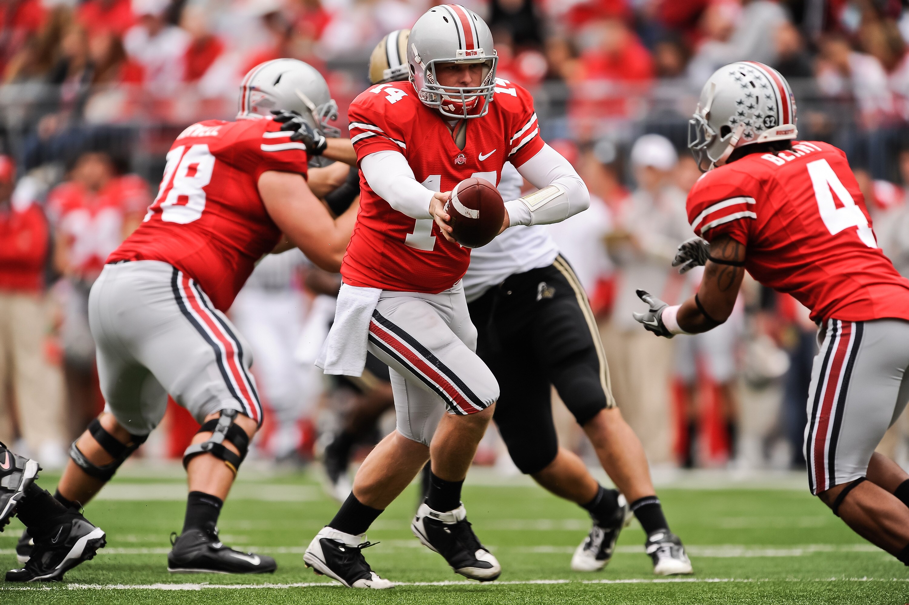 COLUMBUS, OH - OCTOBER 23:  Joe Bauserman #14 of the Ohio State Buckeyes hands off the ball against the Purdue Boilermakers at Ohio Stadium on October 23, 2010 in Columbus, Ohio.  (Photo by Jamie Sabau/Getty Images)
