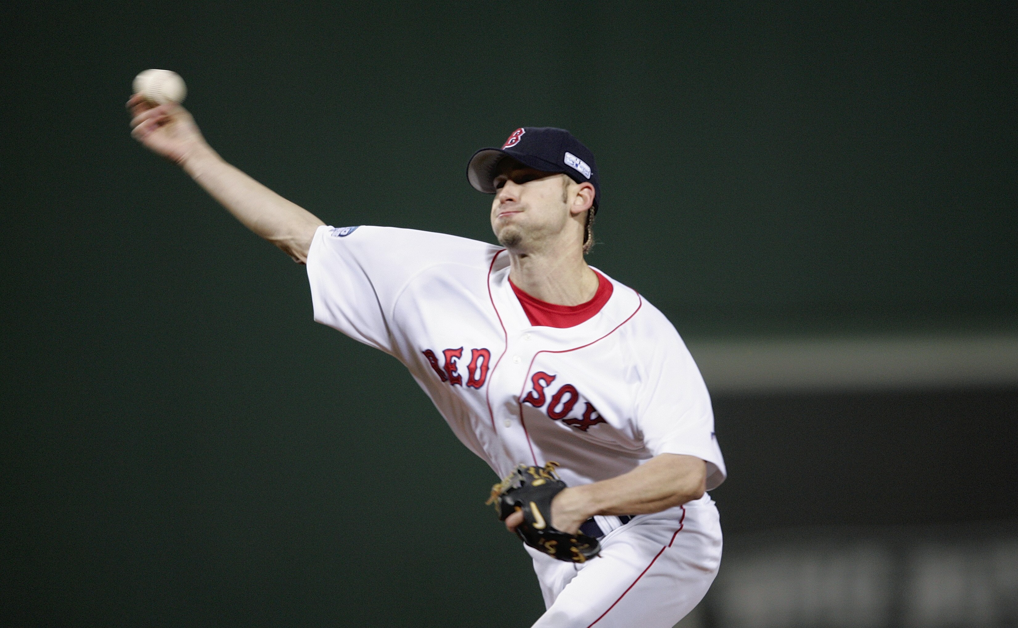 BOSTON - OCTOBER 23:  Bronson Arroyo #61 of the Boston Red Sox pitches against the St. Louis Cardinals during game one of the 2004 World Series on October 23, 2004 at Fenway Park in Boston, Massachusetts. (Photo by Elsa/Getty Images)
