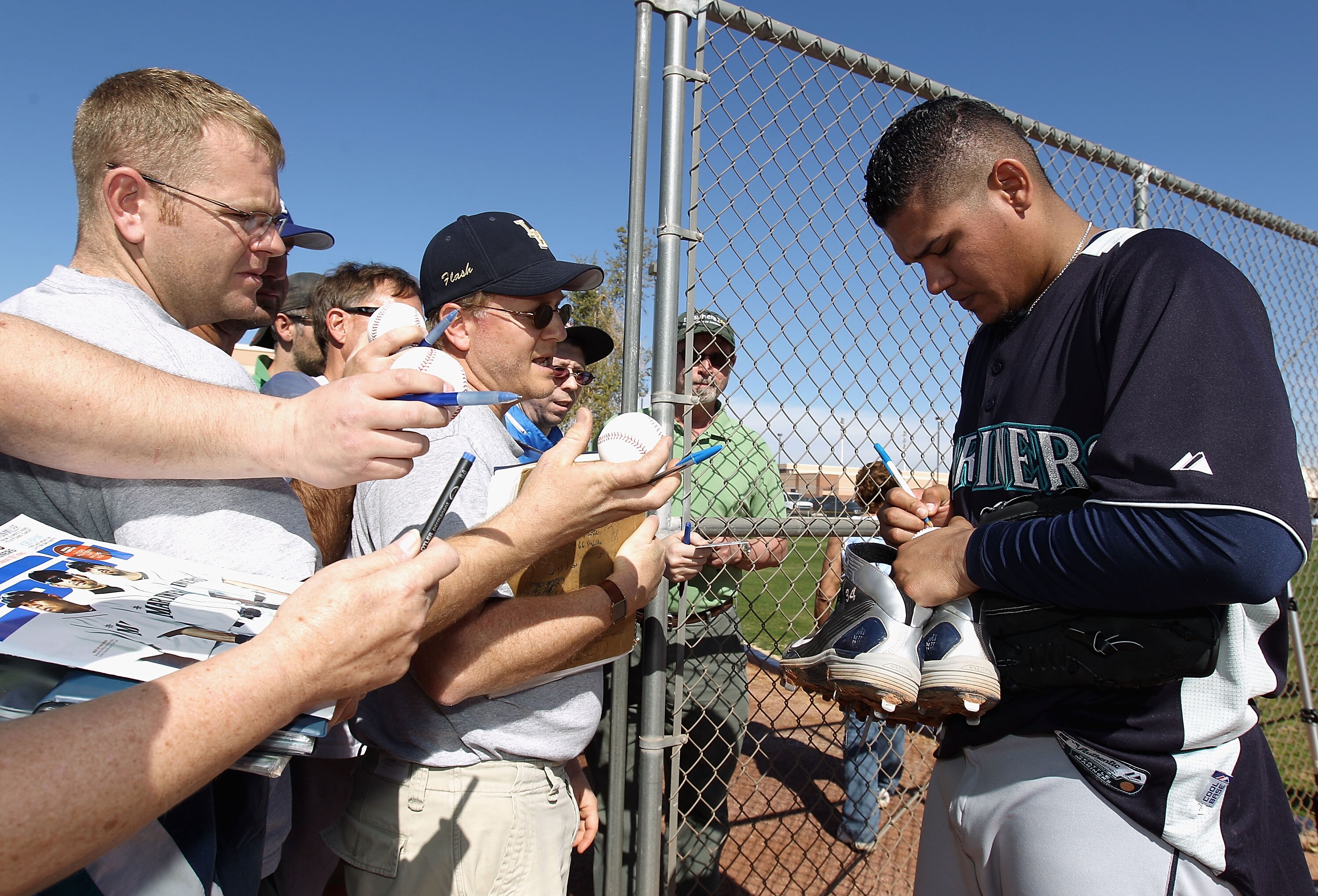 PEORIA, AZ - FEBRUARY 15:  Pitcher Felix Hernandez #34 of the Seattle Mariners signs autographs for fans during a MLB spring training practice at Peoria Stadium on February 15, 2011 in Peoria, Arizona.  (Photo by Christian Petersen/Getty Images)