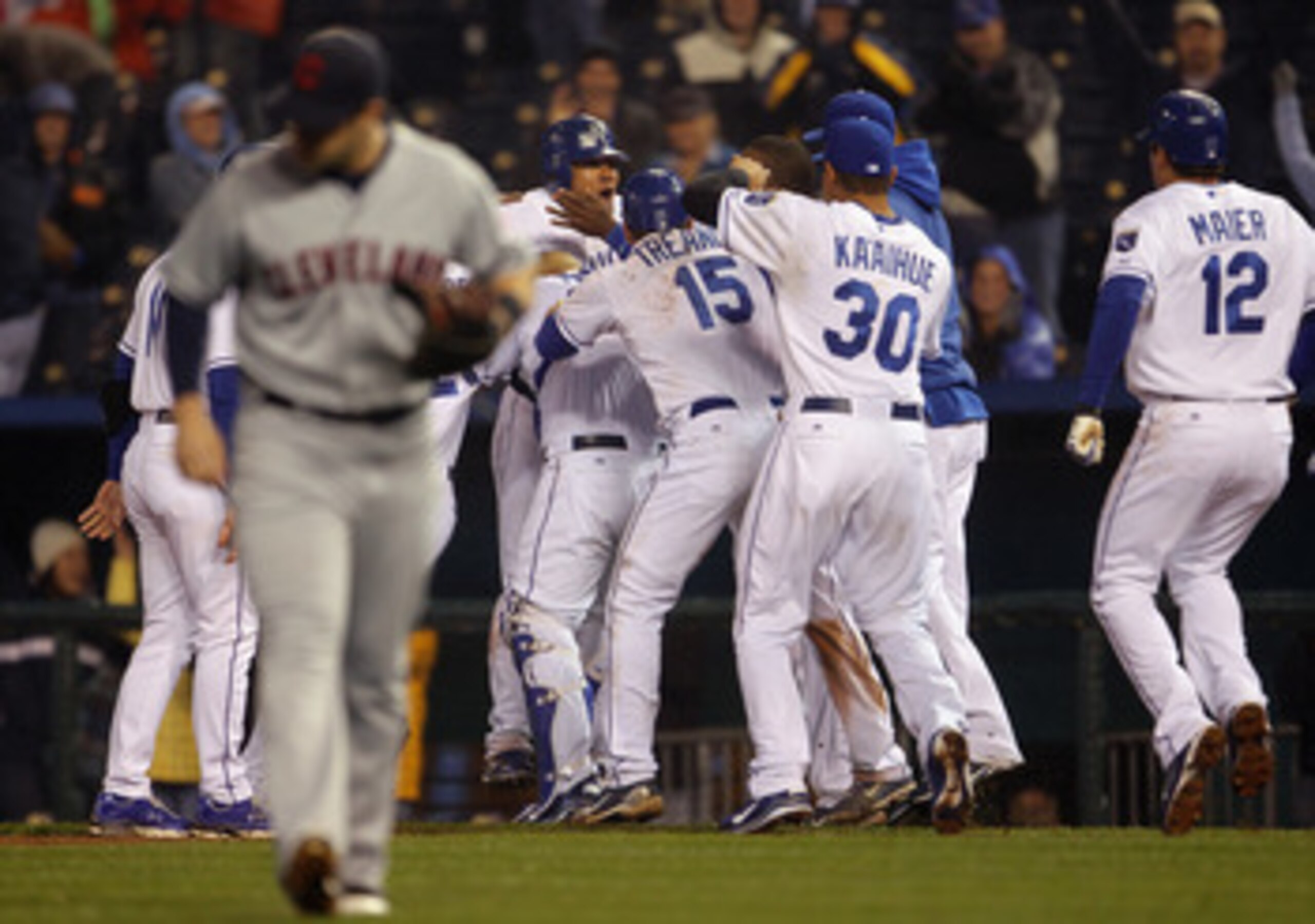 KANSAS CITY, MO - APRIL 21:  Melky Cabrera #53 of the Kansas City Royals is swarmed by teammates after knocking in the game-winning run to defeat  the Cleveland Indians 3-2 to win the game on April 21, 2011 at Kauffman Stadium in Kansas City, Missouri.  (