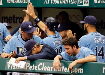 ST. PETERSBURG, FL - MAY 01:  Infielder Ben Zobrist #18 of the Tampa Bay Rays is congratulated by his teammates after scoring a run against the Los Angeles Angels of Anaheim during the game at Tropicana Field on May 1, 2011 in St. Petersburg, Florida.  (P