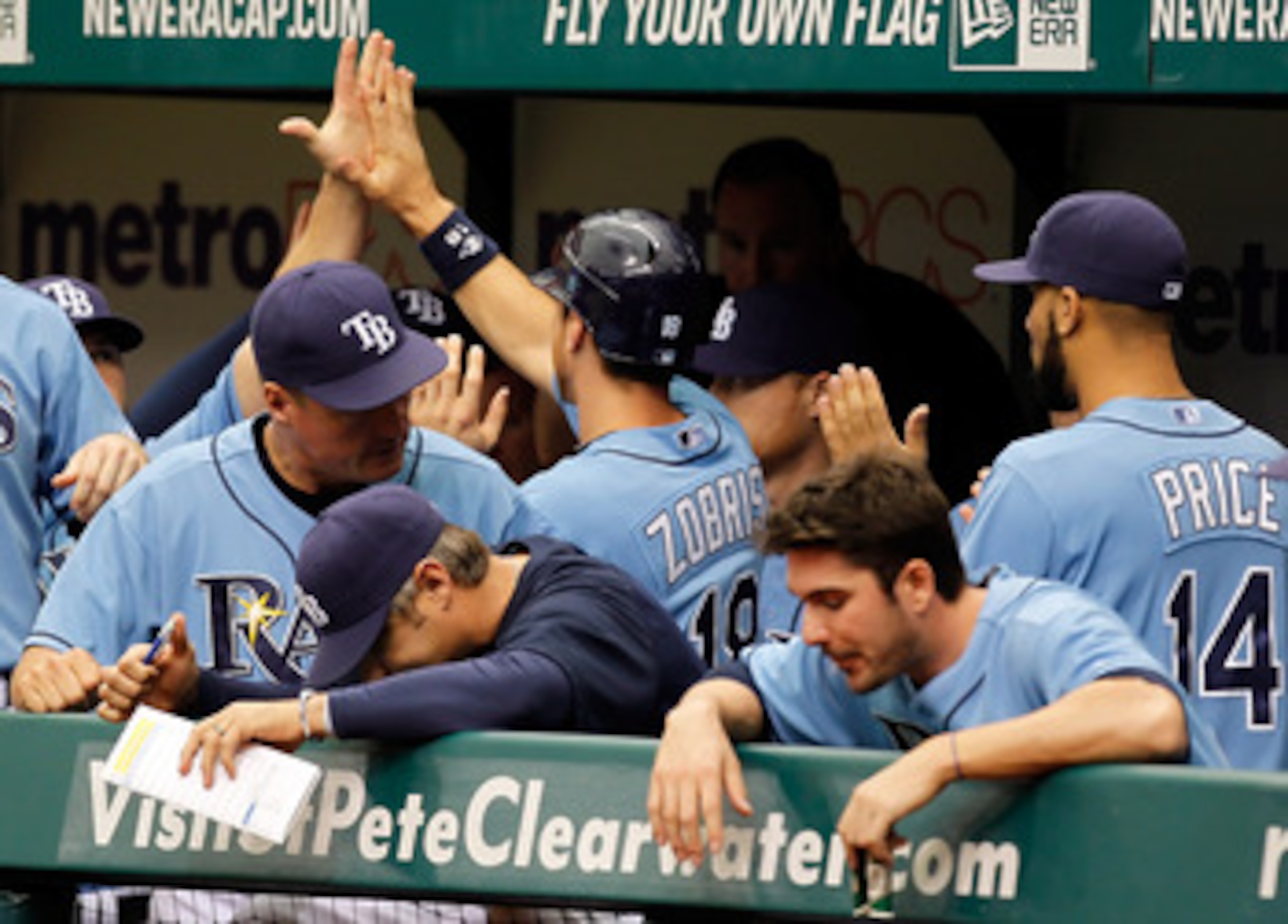 ST. PETERSBURG, FL - MAY 01:  Infielder Ben Zobrist #18 of the Tampa Bay Rays is congratulated by his teammates after scoring a run against the Los Angeles Angels of Anaheim during the game at Tropicana Field on May 1, 2011 in St. Petersburg, Florida.  (P