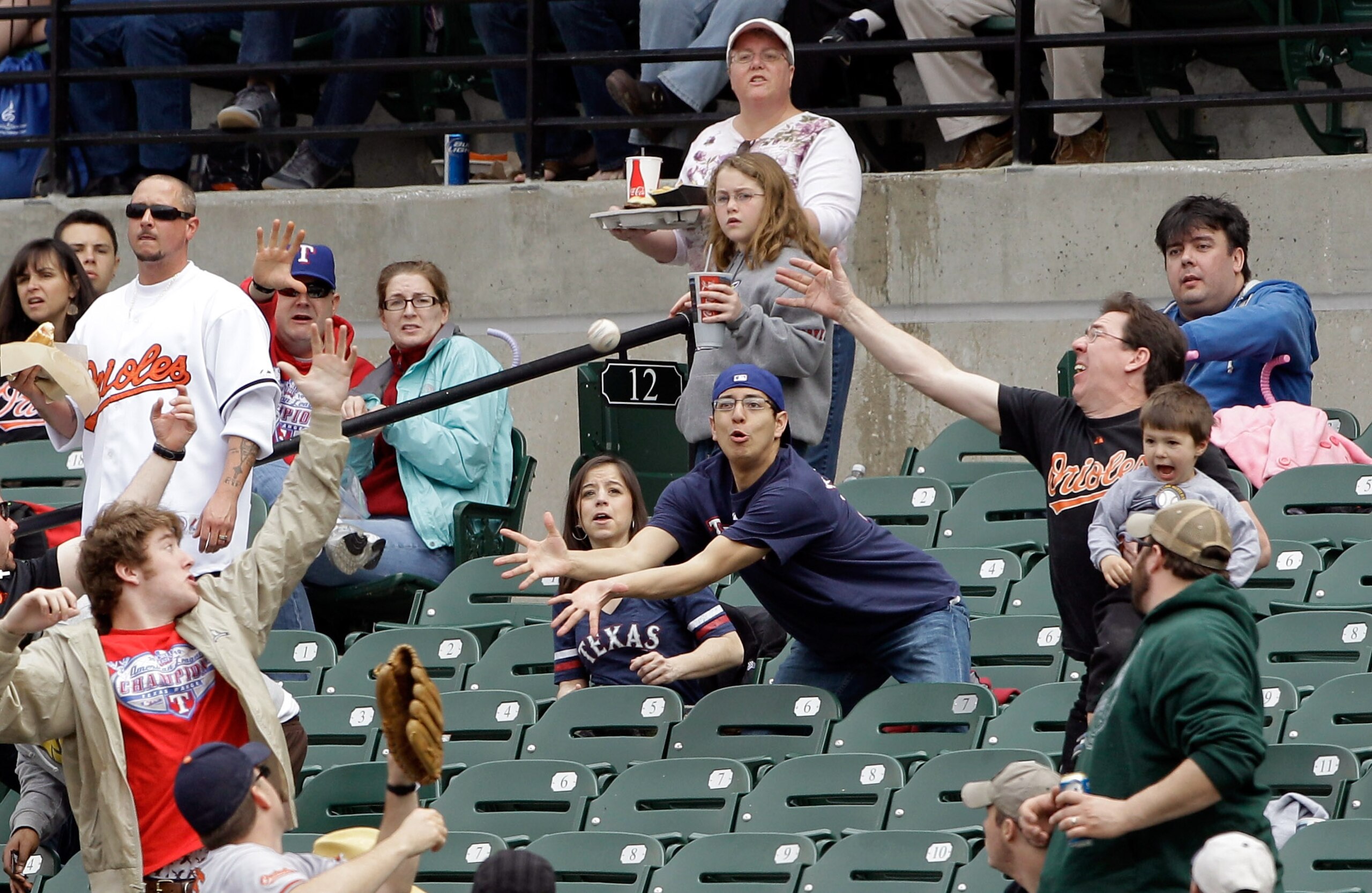 BALTIMORE, MD - APRIL 10: Fans go after a foul ball during the game between the Texas Rangers and Baltimore Orioles at Oriole Park at Camden Yards on April 10, 2011 in Baltimore, Maryland.  (Photo by Rob Carr/Getty Images)