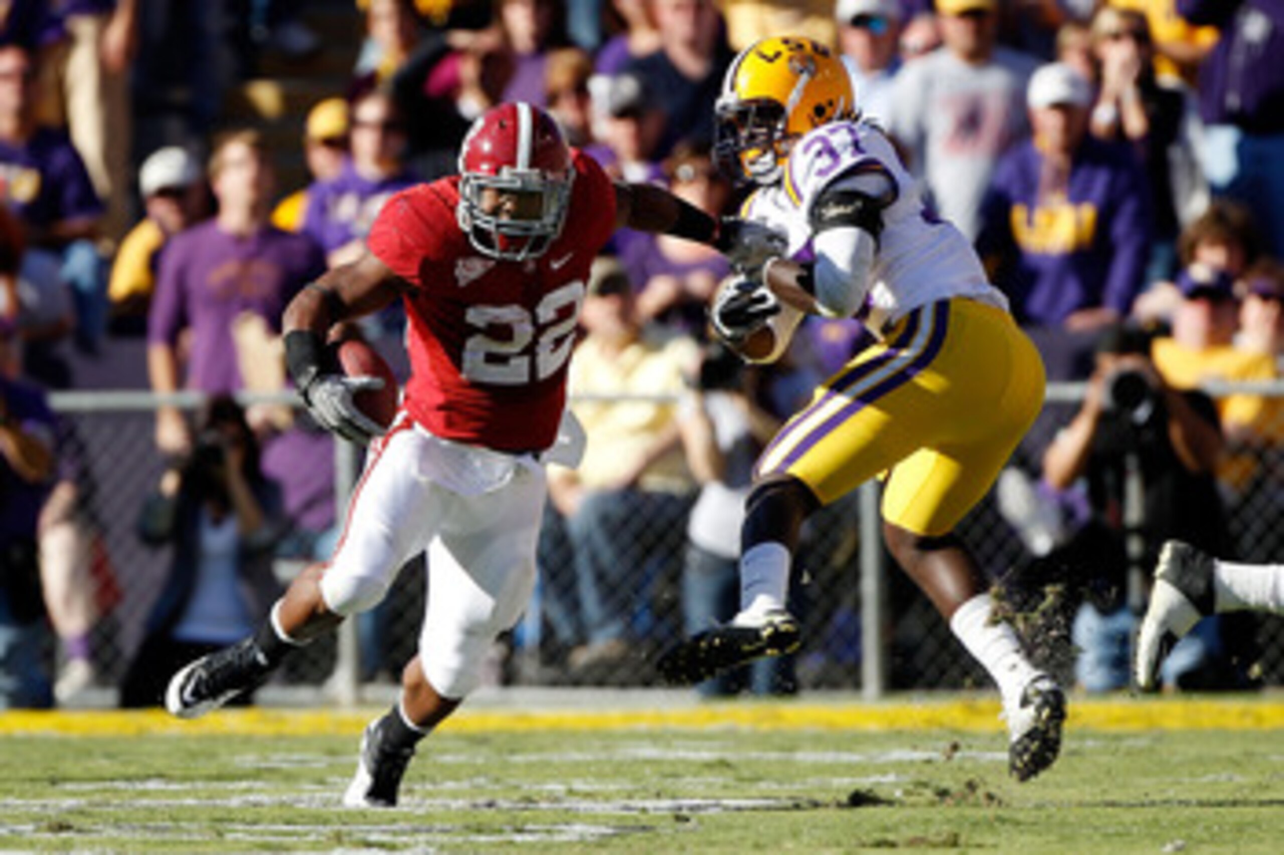 BATON ROUGE, LA - NOVEMBER 06: Mark Ingram #22 of the Alabama Crimson Tide avoids a tackle by Karnell Hatcher #37 of the Louisiana State University Tigers at Tiger Stadium on November 6, 2010 in Baton Rouge, Louisiana. (Photo by Chris Graythen/Getty Ima BATON ROUGE, LA - NOVEMBER 06: Mark Ingram #22 of the Alabama Crimson Tide avoids a tackle by Karnell Hatcher #37 of the Louisiana State University Tigers at Tiger Stadium on November 6, 2010 in Baton Rouge, Louisiana. (Photo by Chris Graythen/Getty Ima