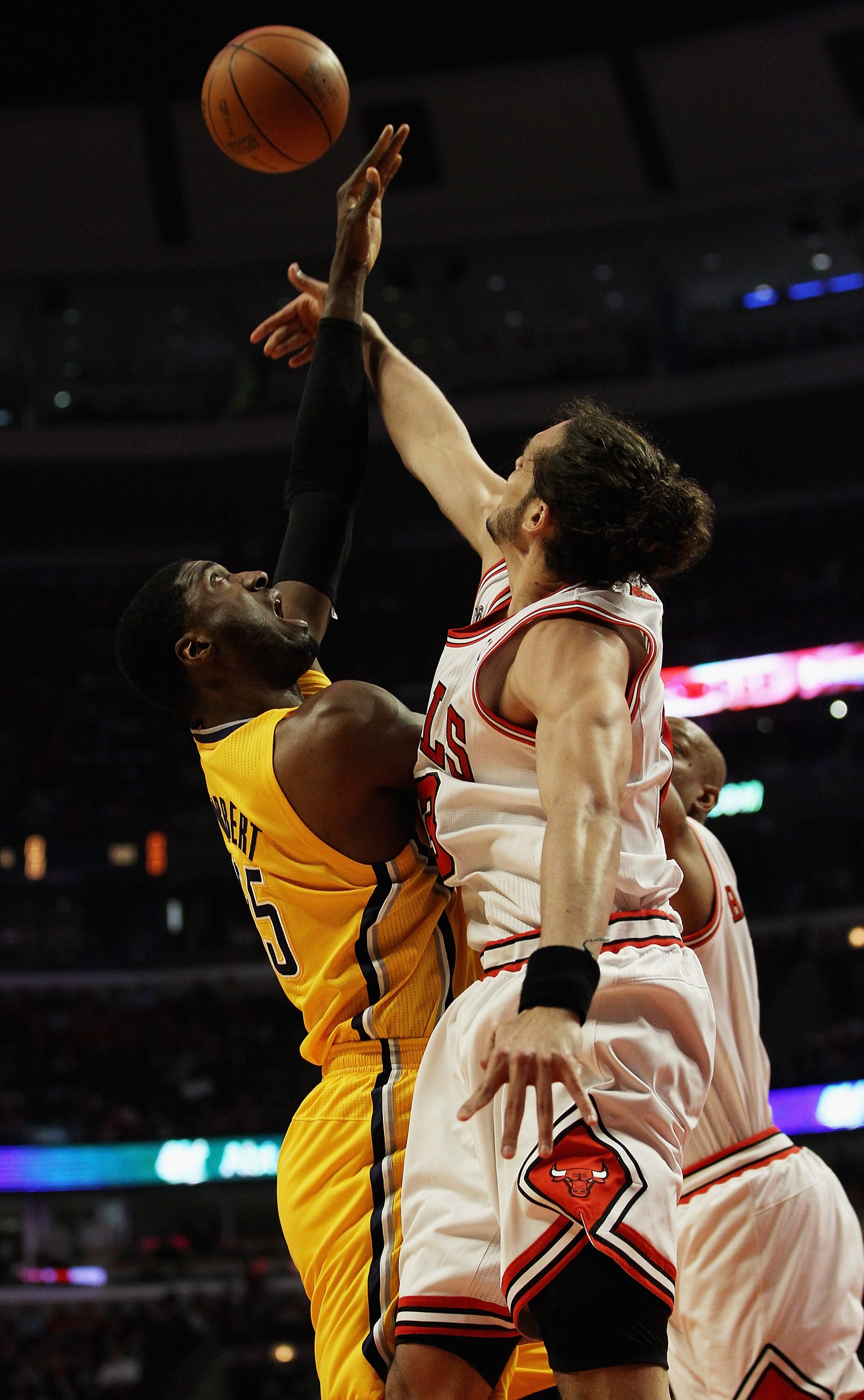 CHICAGO, IL - APRIL 26: Joakim Noah #13 of the Chicago Bulls blocks a shot by Roy Hibbert #55 of the Indiana Pacers in Game Five of the Eastern Conference Quarterfinals in the 2011 NBA Playoffs at the United Center on April 26, 2011 in Chicago, Illinois.
