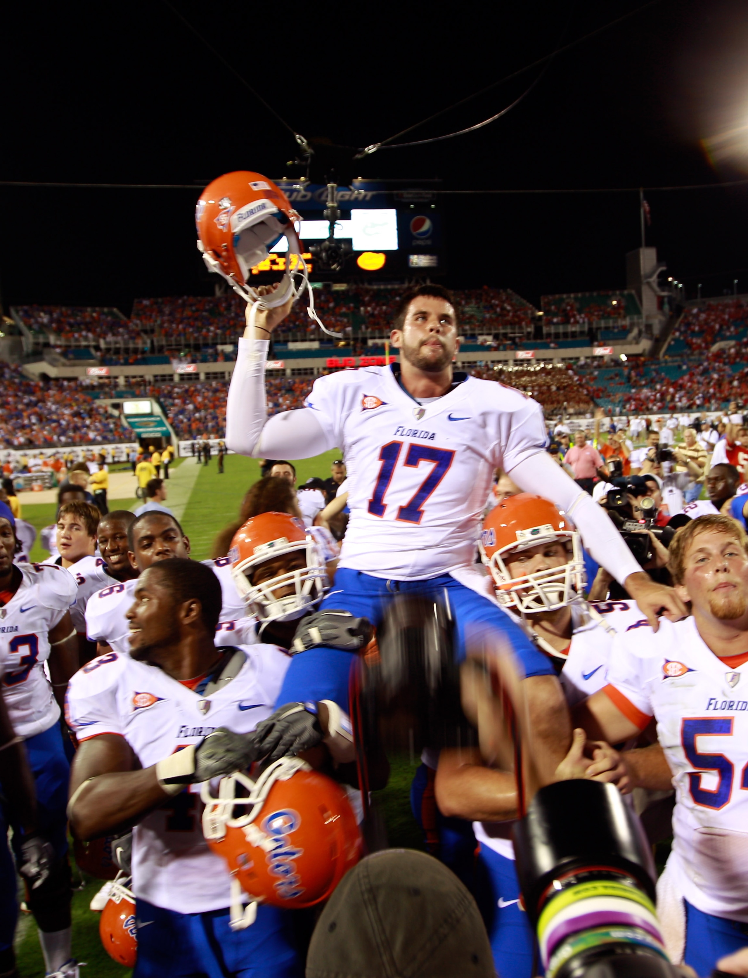 JACKSONVILLE, FL - OCTOBER 30:  Chas Henry #17 of the Florida Gators raises his helmet in vicrtory following the game against the Georgia Bulldogs at EverBank Field on October 30, 2010 in Jacksonville, Florida.  (Photo by Sam Greenwood/Getty Images)