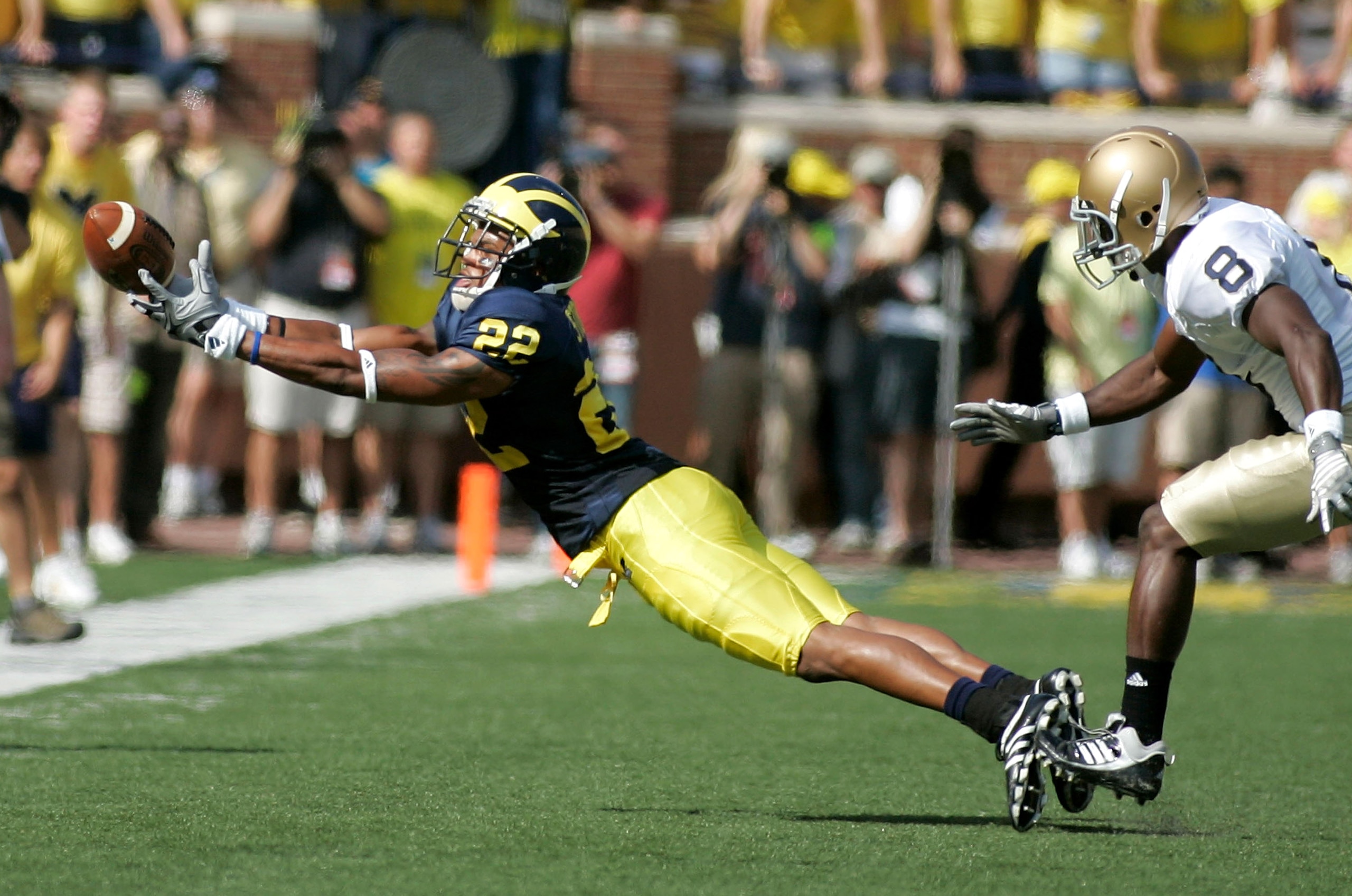 ANN ARBOR, MI - SEPTEMBER 12:  Wide reciever Darryl Stonum #22 misses a catch early in the first half against Notre Dame at Michigan Stadium on September 12, 2009 in Ann Arbor, Michigan.  (Photo by Domenic Centofanti/Getty Images)