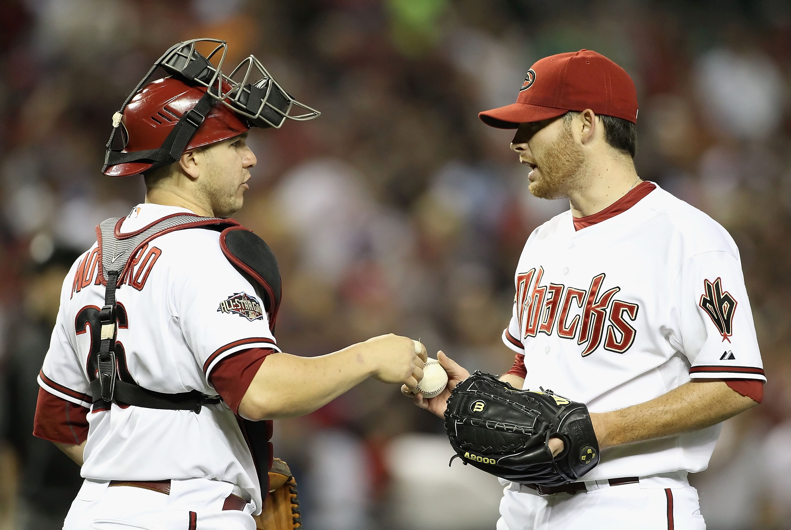 PHOENIX, AZ - APRIL 25:  Starting pitcher Ian Kennedy #31 of the Arizona Diamondbacks reacts with catcher Miguel Montero #26 after defeating the Philadelphia Phillies in the Major League Baseball game at Chase Field on April 25, 2011 in Phoenix, Arizona.
