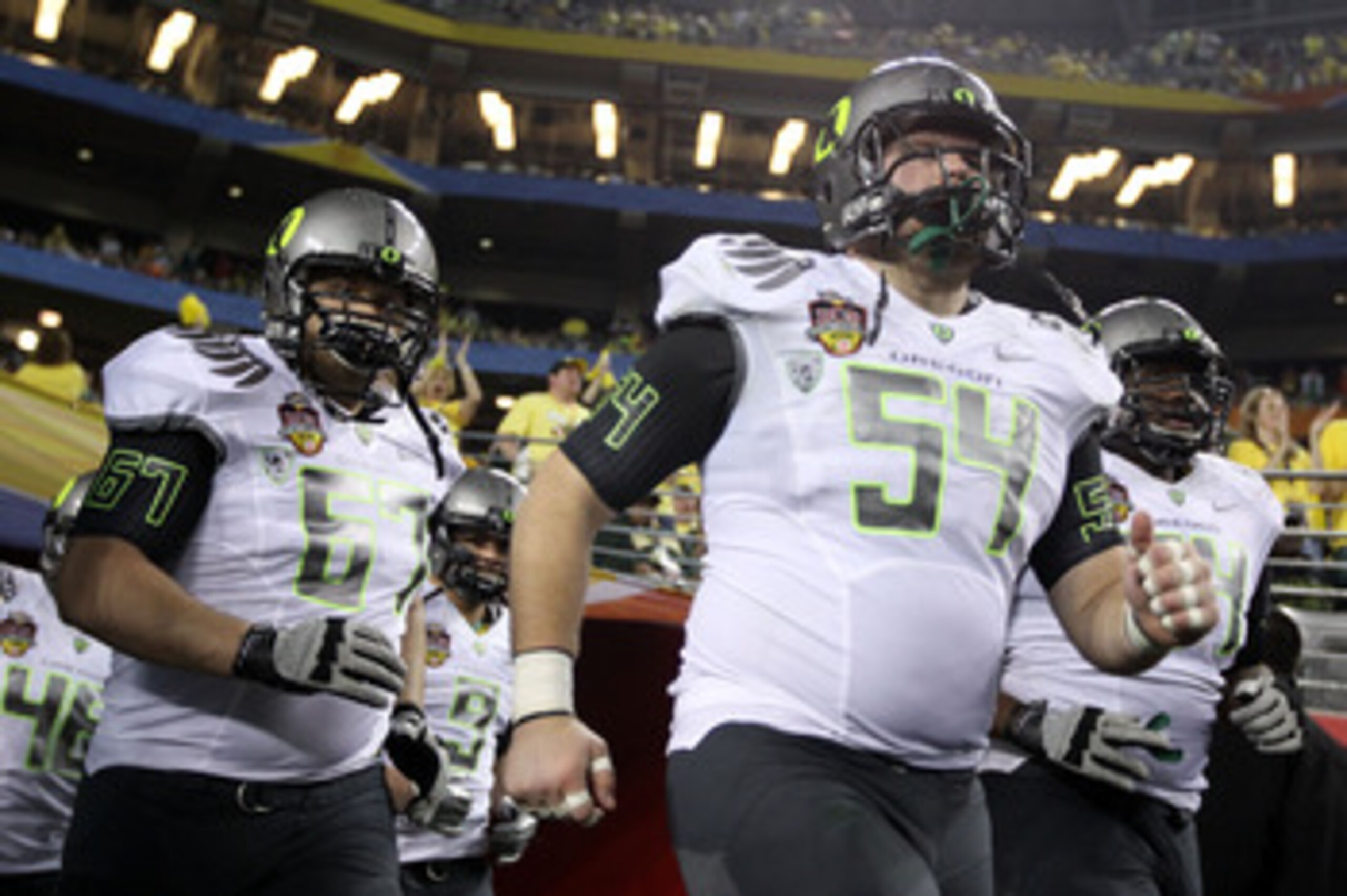 GLENDALE, AZ - JANUARY 10: Jordan Holmes #54 and Josh Sanford #67 of the Oregon Ducks take the field for their game against the Auburn Tigers at the Tostitos BCS National Championship Game at University of Phoenix Stadium on January 10, 2011 in Glendale, GLENDALE, AZ - JANUARY 10: Jordan Holmes #54 and Josh Sanford #67 of the Oregon Ducks take the field for their game against the Auburn Tigers at the Tostitos BCS National Championship Game at University of Phoenix Stadium on January 10, 2011 in Glendale,