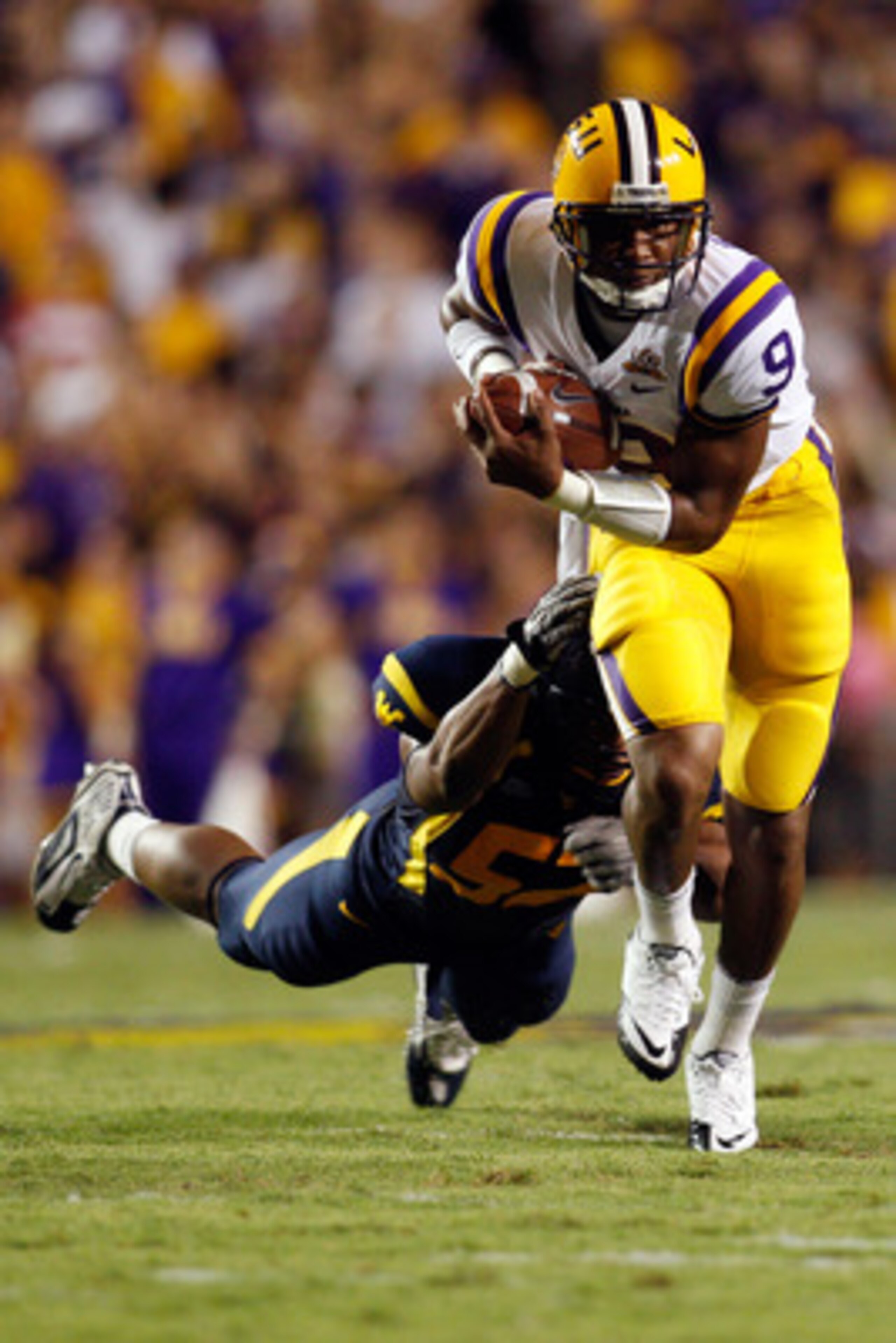 BATON ROUGE, LA - SEPTEMBER 25: Jordan Jefferson #9 of the Louisiana State Univeristy Tigers avoids a tackle by Najee Goode #52 of the West Virginia Mountaineers at Tiger Stadium on September 25, 2010 in Baton Rouge, Louisiana. (Photo by Chris Graythen/ BATON ROUGE, LA - SEPTEMBER 25: Jordan Jefferson #9 of the Louisiana State Univeristy Tigers avoids a tackle by Najee Goode #52 of the West Virginia Mountaineers at Tiger Stadium on September 25, 2010 in Baton Rouge, Louisiana. (Photo by Chris Graythen/