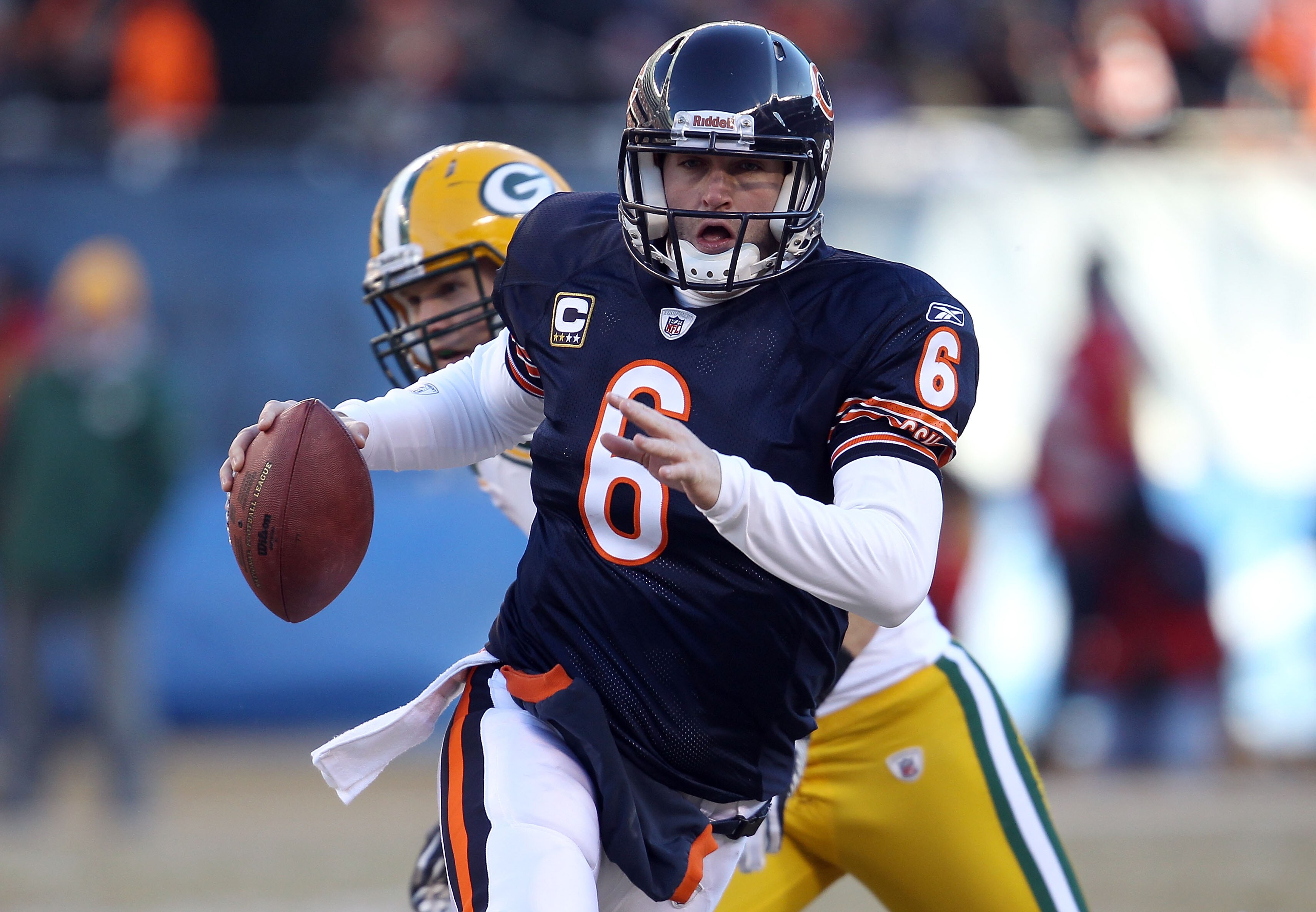 CHICAGO, IL - JANUARY 23:  Quarterback Jay Cutler #6 of the Chicago Bears runs the ball ahead of Clay Matthews #52 of the Green Bay Packers in the second quarter of the NFC Championship Game at Soldier Field on January 23, 2011 in Chicago, Illinois.  (Pho