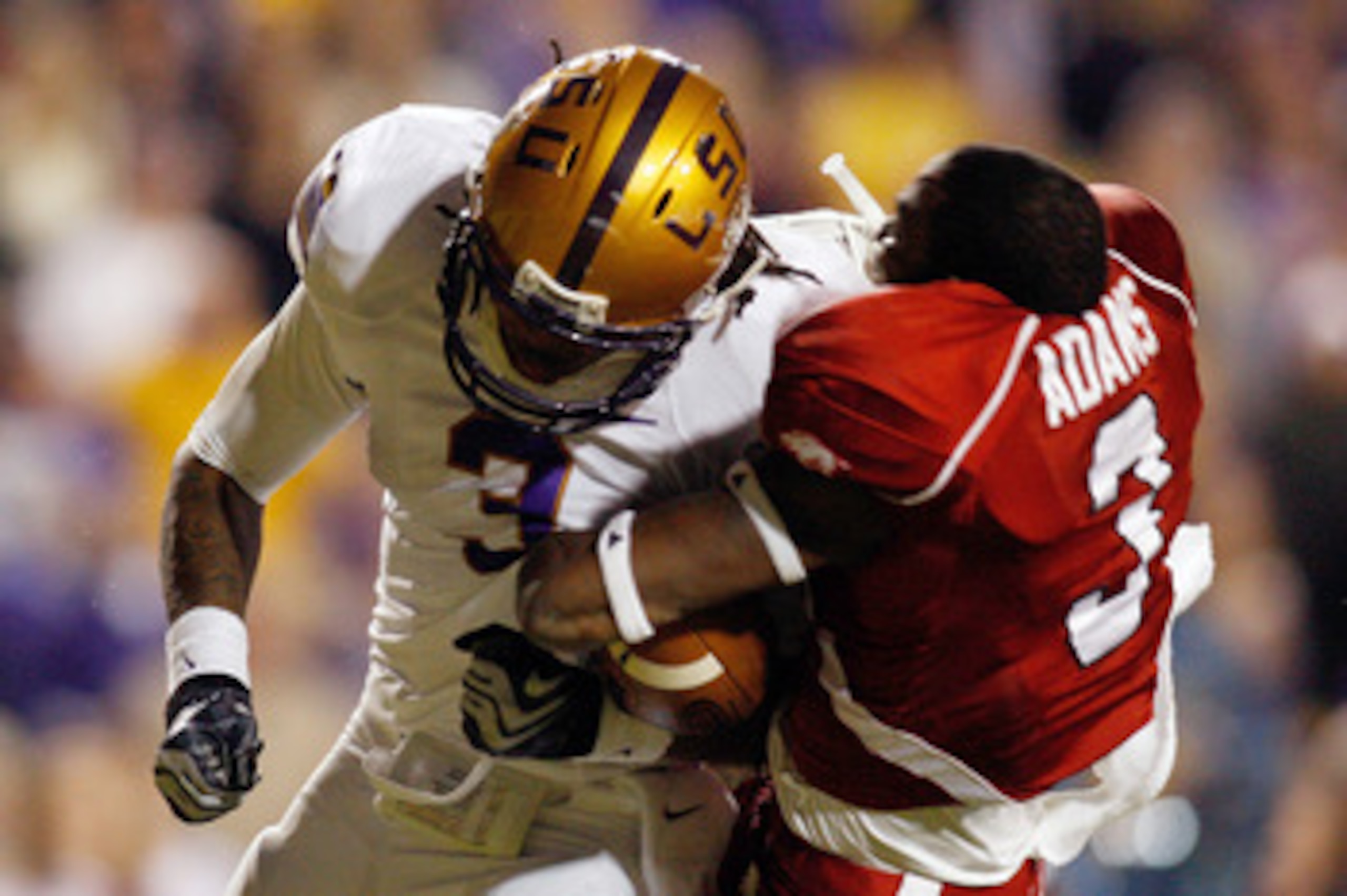 BATON ROUGE, LA - NOVEMBER 28: Chad Jones #3 of the LSU Tigers knocks off the helmet of Joe Adams #3 of the Arkansas Razorbacks at Tiger Stadium on November 28, 2009 in Baton Rouge, Louisiana. The Tigers defeated the Razorbacks 33-30 in overtime. (Pho BATON ROUGE, LA - NOVEMBER 28: Chad Jones #3 of the LSU Tigers knocks off the helmet of Joe Adams #3 of the Arkansas Razorbacks at Tiger Stadium on November 28, 2009 in Baton Rouge, Louisiana. The Tigers defeated the Razorbacks 33-30 in overtime. (Pho