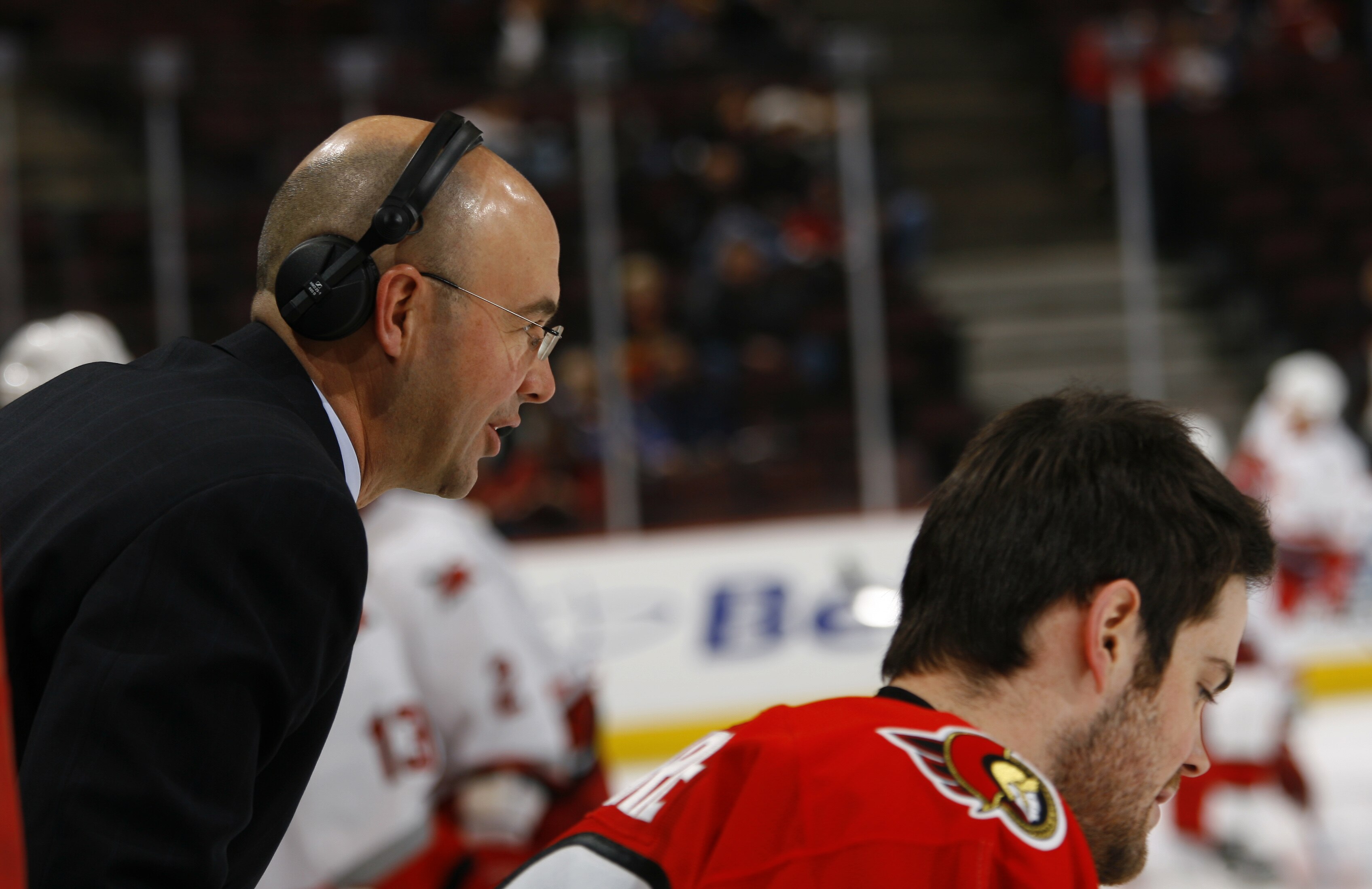 OTTAWA, CANADA - FEBRUARY 28:  Pierre McGuire of TSN leans over to talk to Mike Comrie #89 of the Ottawa Senators during warmup before a game against the Carolina Hurricanes on February 28, 2007 at the Scotiabank Place in Ottawa, Canada. The Ottawa Senato