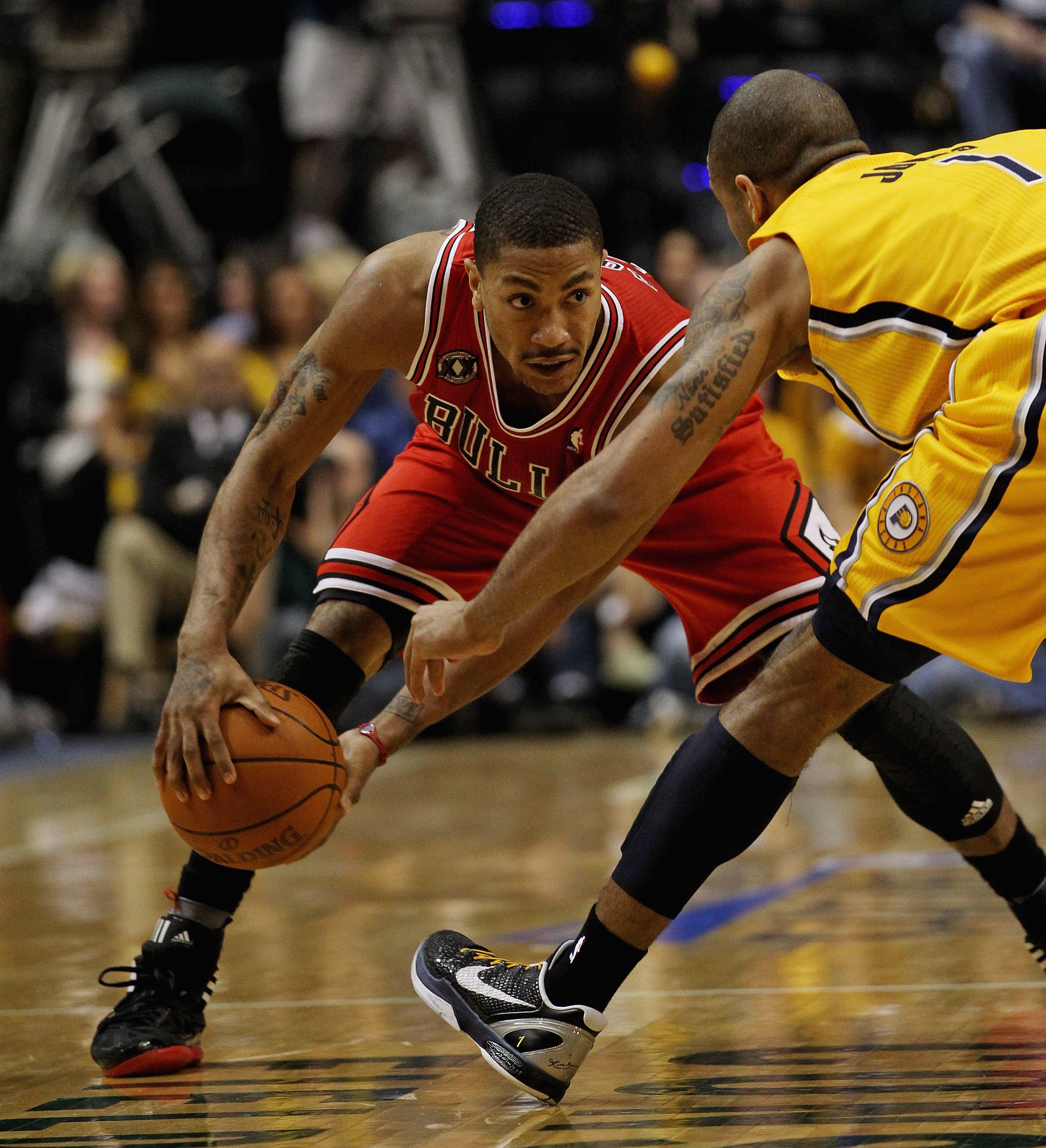 INDIANAPOLIS, IN - APRIL 23: Derrick Rose #1 of the Chicago Bulls moves against Dahntay Jones #1 of the Indiana Pacers in Game Four of the Eastern Conference Quarterfinals in the 2011 NBA Playoffs at Conseco Fieldhouse on April 23, 2011 in Indianapolis, I